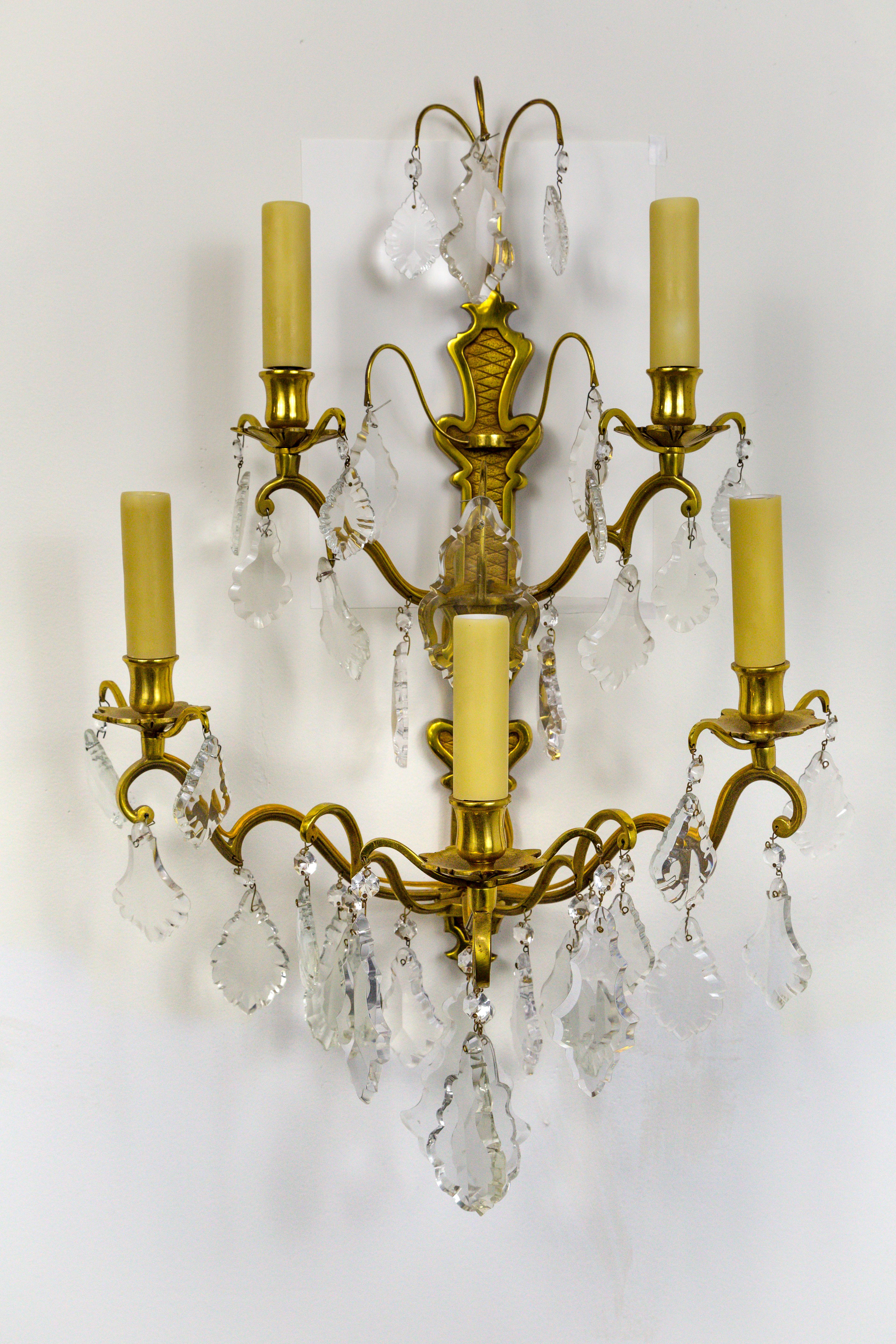 A lovely pair of French gilded bronze, double tier, five-arm, candelabra sconces in the Belle Époque style. With heavy, French pendalogue crystals, and polybeeswax candle covers, circa 1910.
Newly rewired. Measures: 17
