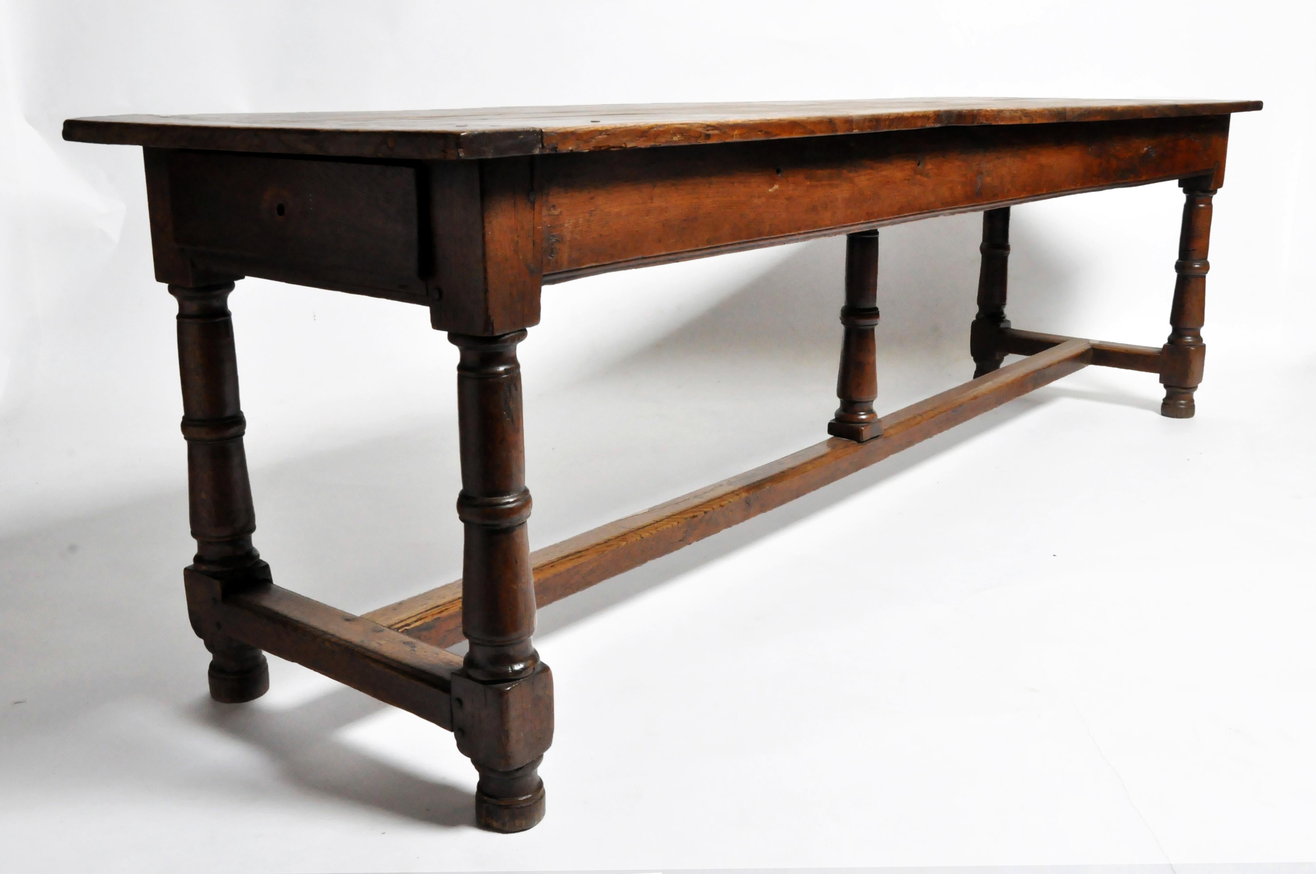 This impressive draper's table is from France and dates to the 19th century and is made from solid oak. The table features two drawers and a beautiful aged patina. The sides and legs retain some of their original darker finish and some antique