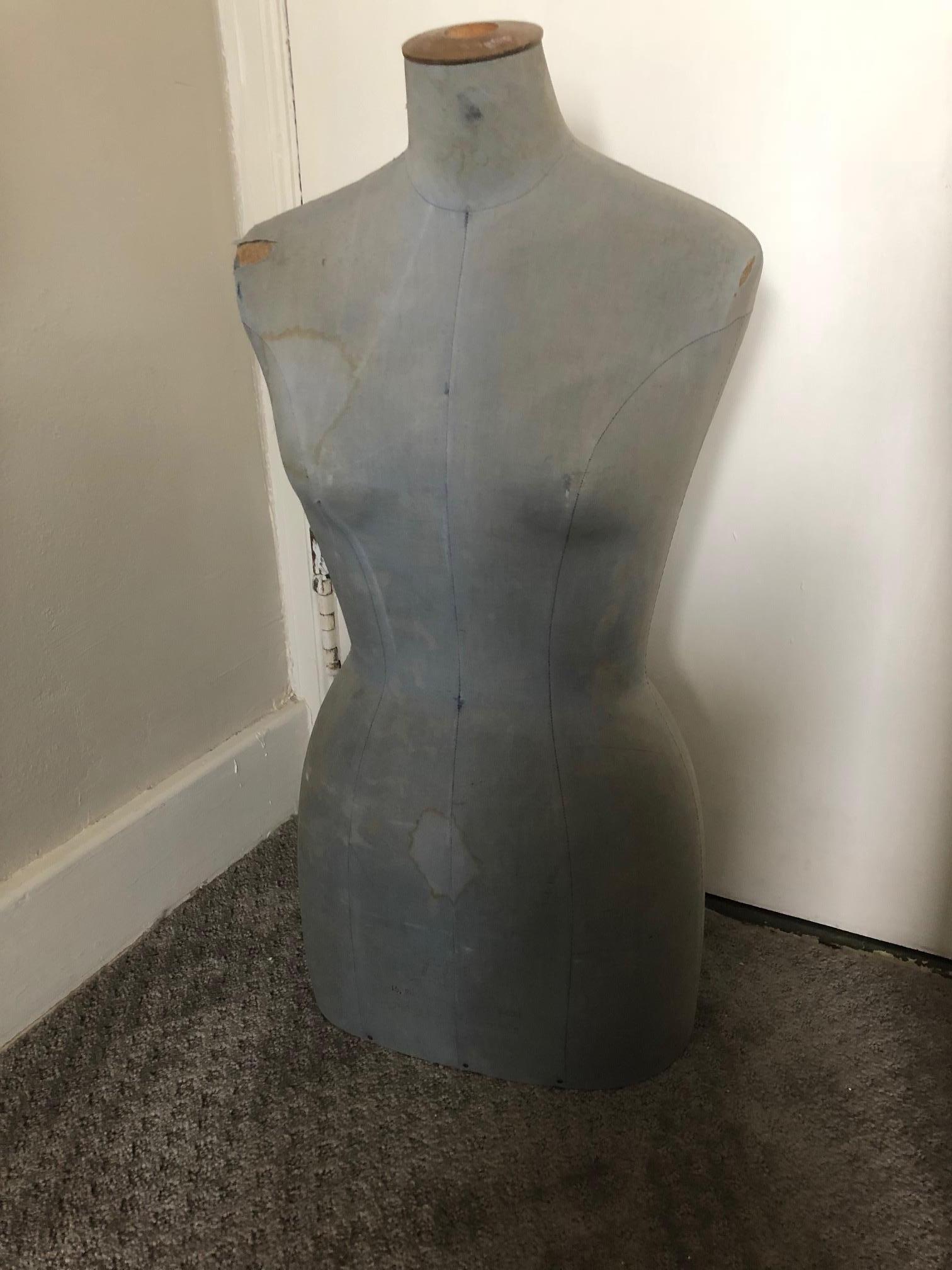 French dress form bust from Paris Opera costuming department. Tabletop model in light blue denim color. Hectic working years of use has left faded stains and slight tears in fabric that are as much apart of the bust's character as they are the