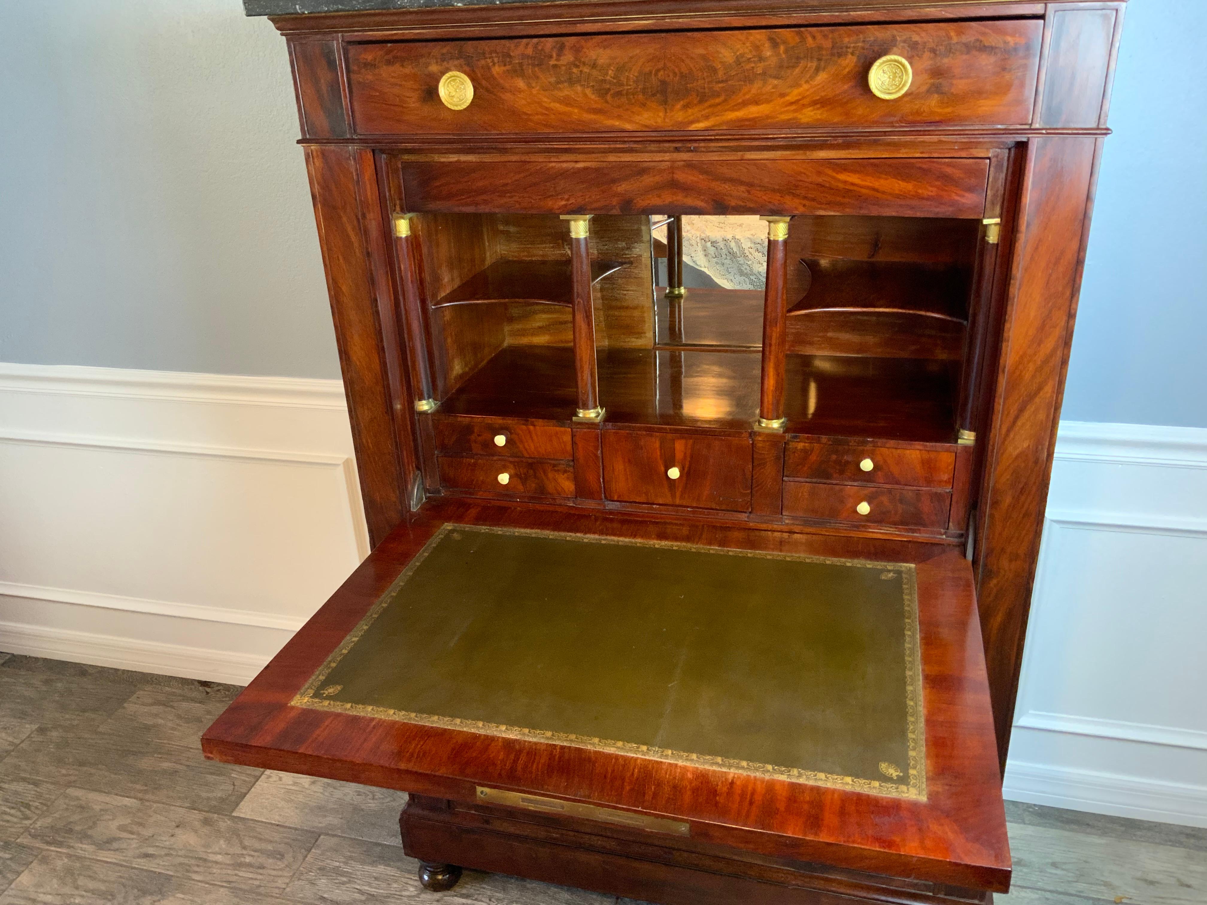 A very attractive French Drop Front Secretary in a highly figured crotch Mahogany veneer over a Pine case wood. Excellent form and color and a nicely aged patina on the old and possibly original surface. There is a secret well compartment housing