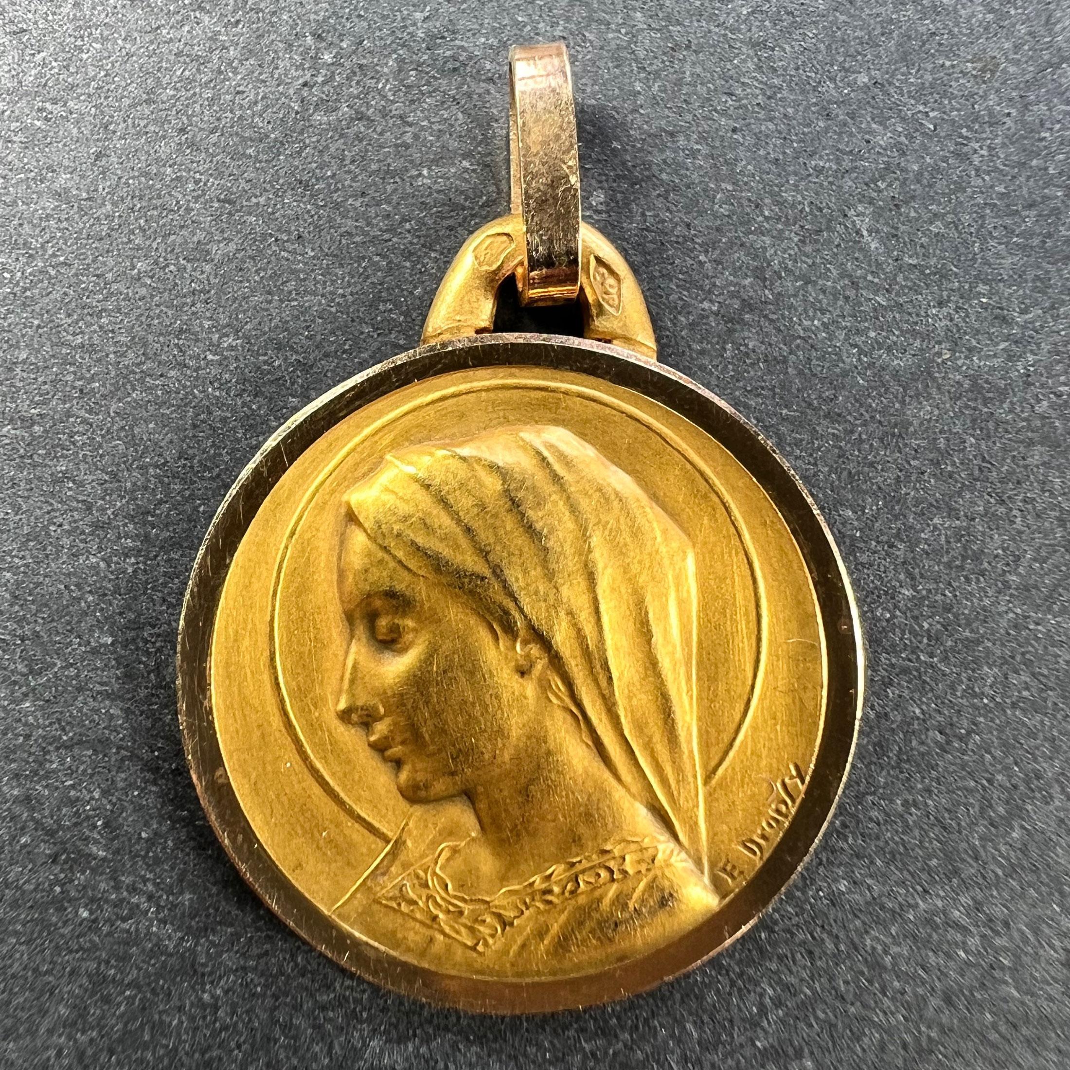 A French 18 karat (18K) yellow gold pendant designed as a round medal depicting the Virgin Mary within a halo. Signed E. Dropsy. Stamped with the eagle’s head for French manufacture and 18 karat gold, with maker’s mark for Perriat.

Dimensions: 2.3