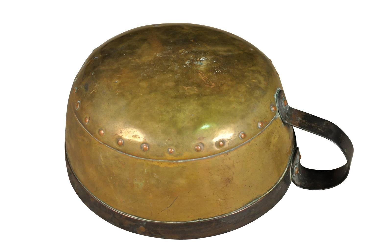 A very beautiful early 18th century riveted copper vessel or bowl with an iron handle. A charming and warm accent piece for any kitchen, living area or bath.