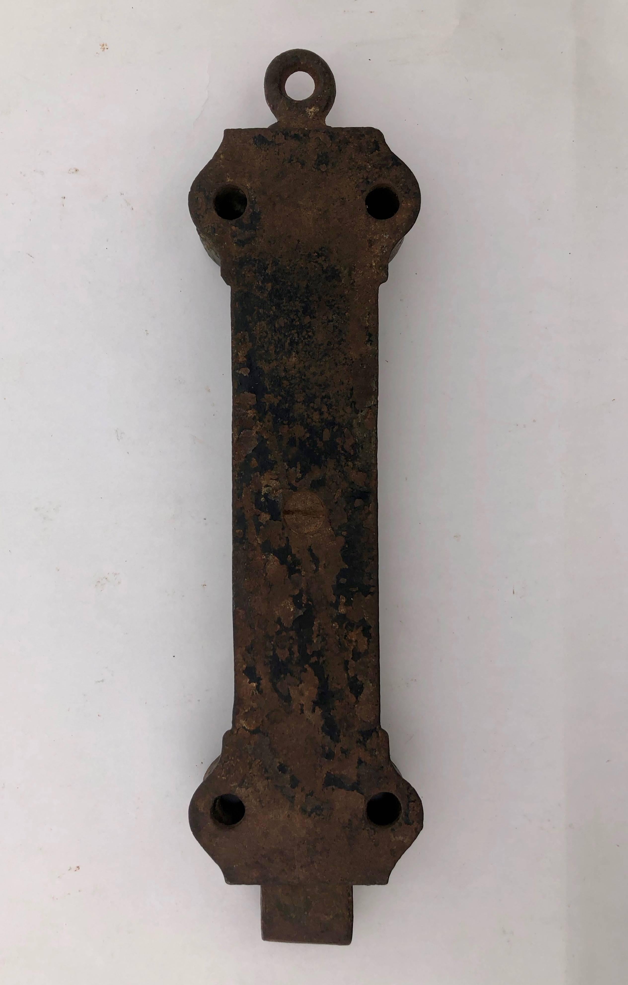 This is an early 1900s French cast iron door top (or bottom) lock. It has a great patina and a great decorative detailed design.