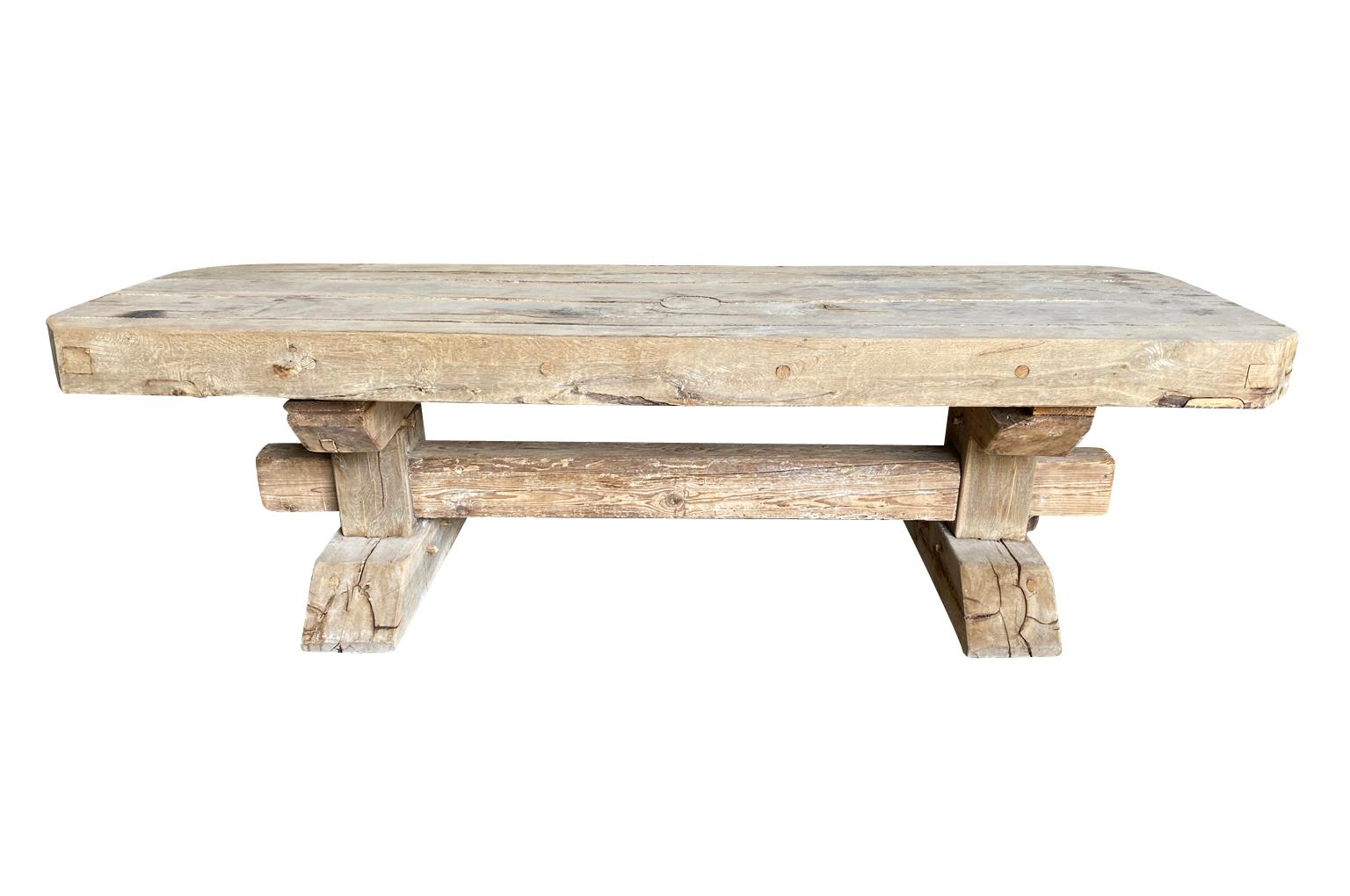 An exceptional grand scale Arte Populaire dining table from the South of France. Wonderfully constructed from from oak and pine with a very thick top, stretcher and feet. The thick top simply rests atop of the base trestle. A wonderful table for