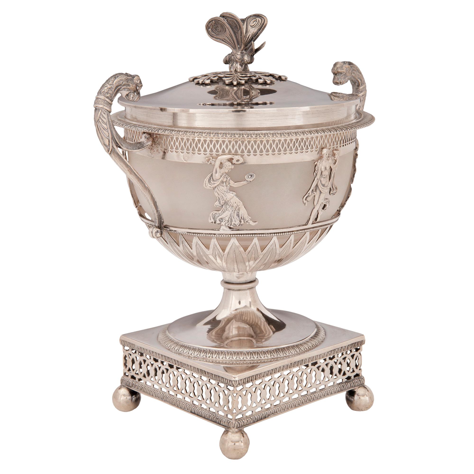 An elegant French early 19th century 1st Empire period signed sterling silver lidded urn. The urn is raised by four ball feet below the lovely intricately pierced base decorated with interlocking geometric patterns and fine Coeur de Rai wrap around