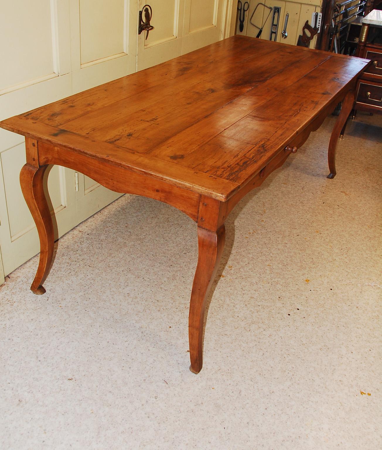 French provincial cherry farm house table from the Burgundy region of France. This table is earlier than most farm house tables that we come across and is a handsome example of a country table that has been well cared for throughout its life.