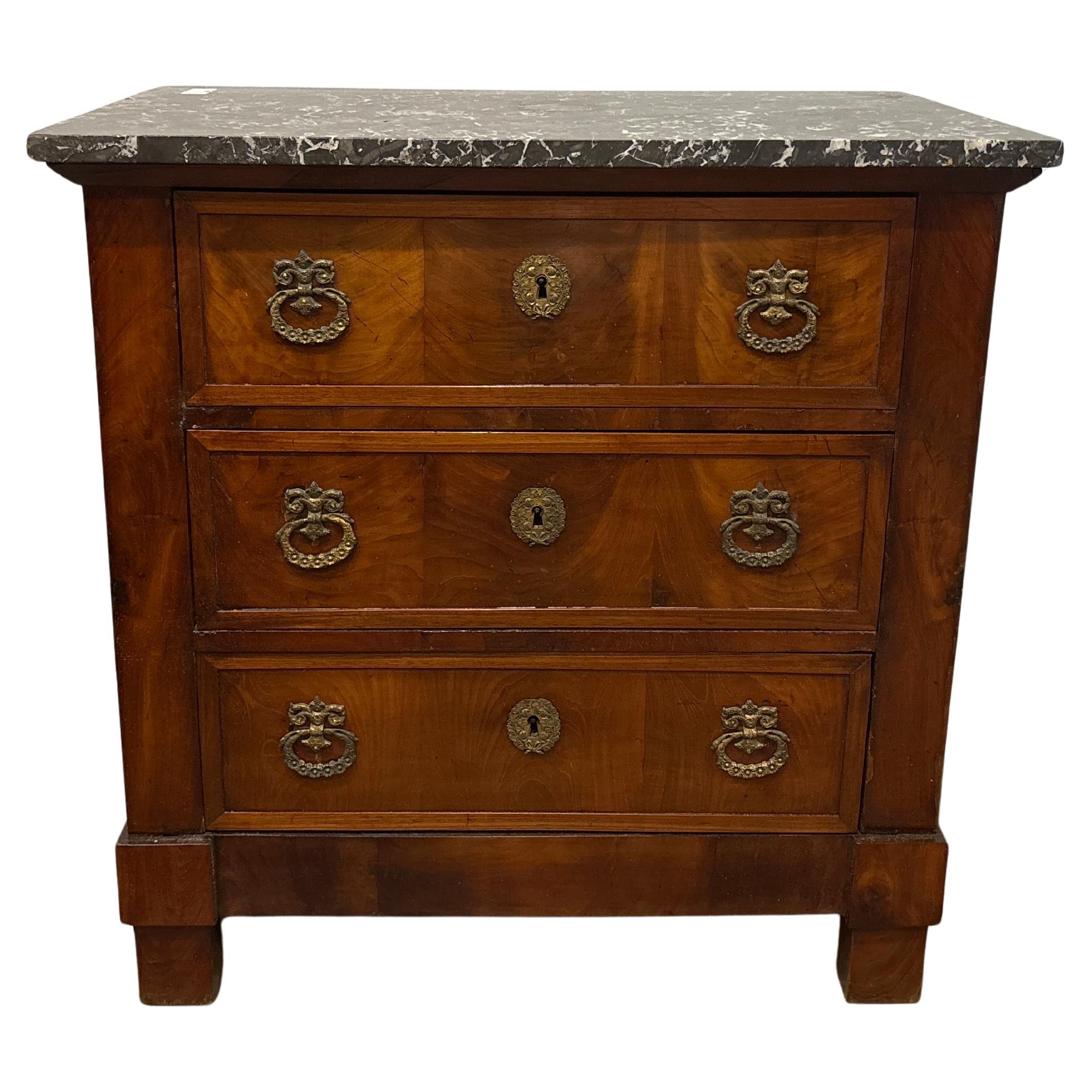 This is a charming piece, it is made of mahogany with a Saint-Anne marble top.