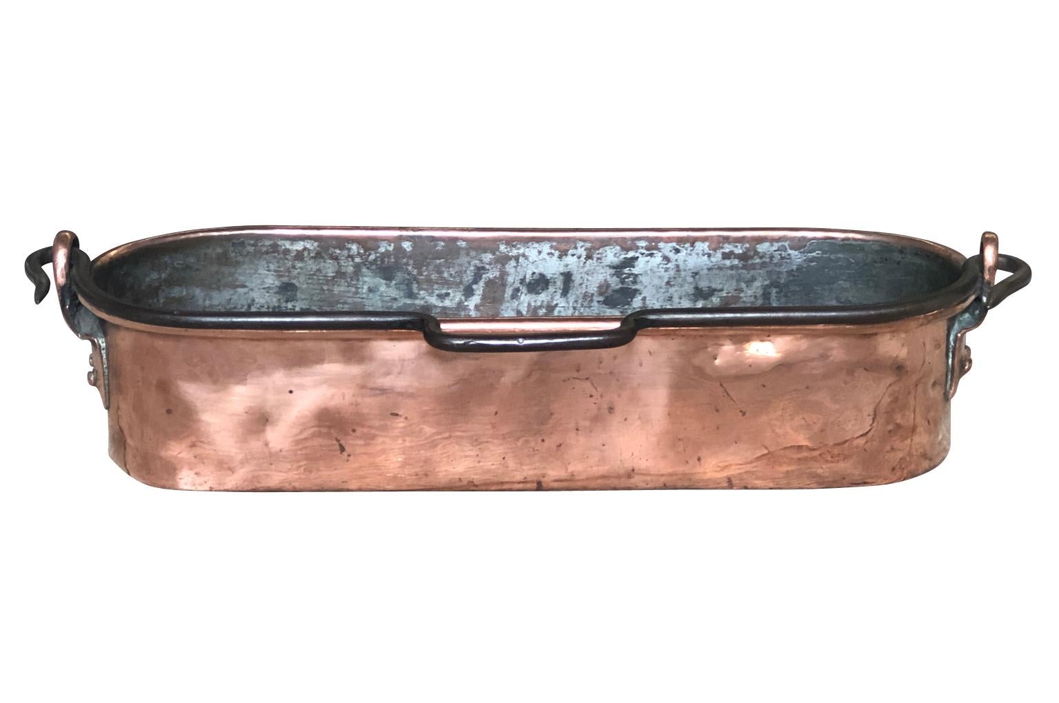 A very handsome early 19th century fish pan beautifully crafted from heavy gauge copper from the Provence region of France. A lovely accent piece for any kitchen, bathroom or table top.