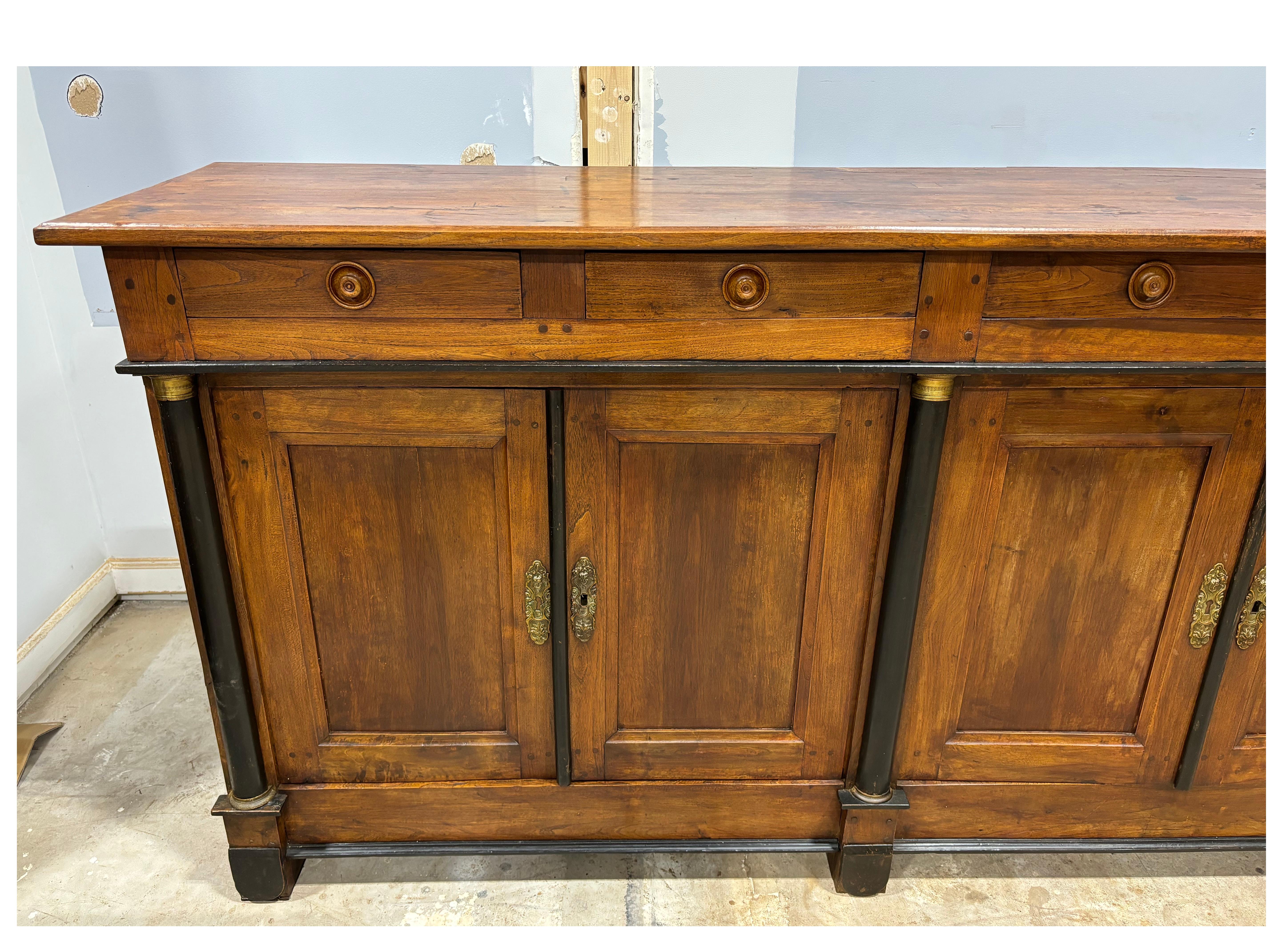 Magnificent French Empire Period Sideboard is made of walnut with brass rings around the columns. 