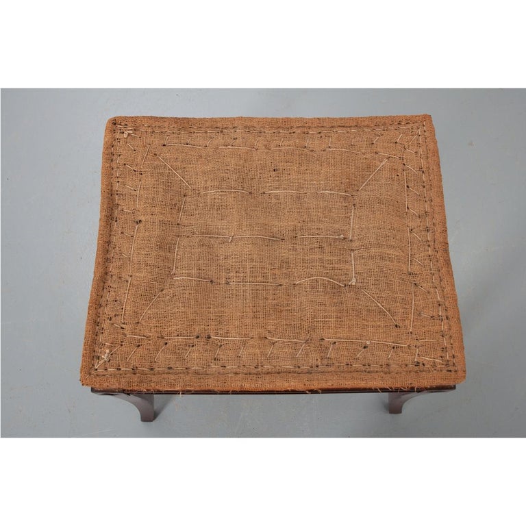 An elegant Empire style stool from early 19th century, France, circa 1830. The small, rectangle stool is made from mahogany with diamond shapes carved into the corner dies and the apron has a recessed style panel on each side. Add new upholstery and