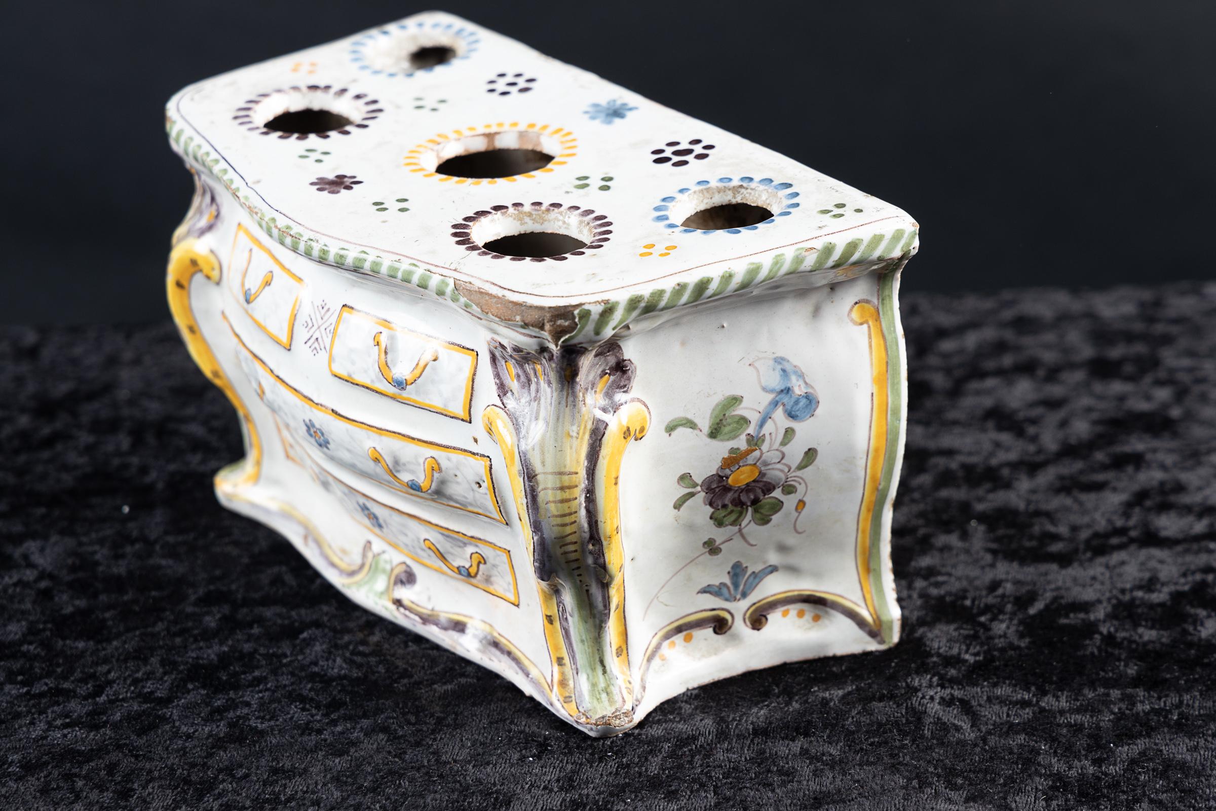 French early 19th century faience wall pocket in the form of a Louis XV Bombe` chest of drawers.  The form is very Country French, hand-painted with flowers,  and painting to show bronze  mounts.