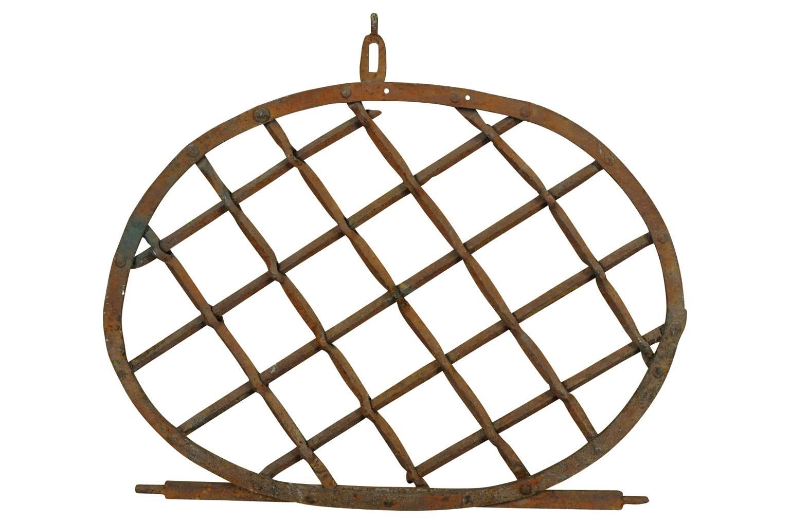 A terrific early 19th century iron window guard. Originally, the window guard would have been hinged to open easily. Wonderful as an architectural wall hanging for an interior of exterior.