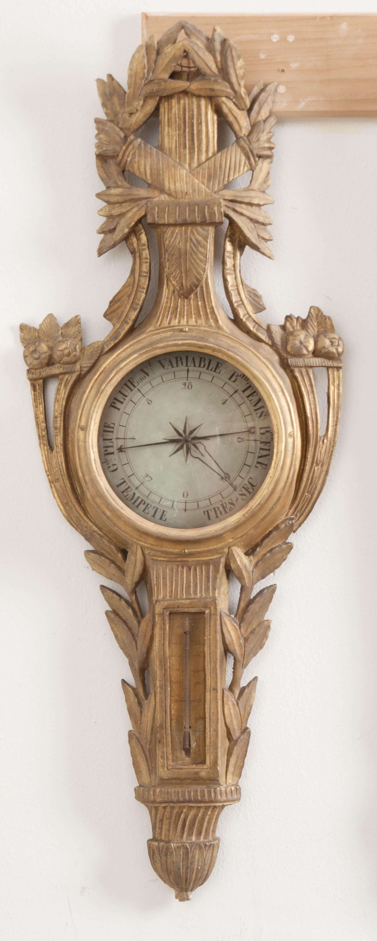 A gorgeous gold gilt barometer from the early part of the 19th century, France. This early scientific instrument was used to measure atmospheric pressure in order to better predict the weather. This antique piece has both a barometer as well as a