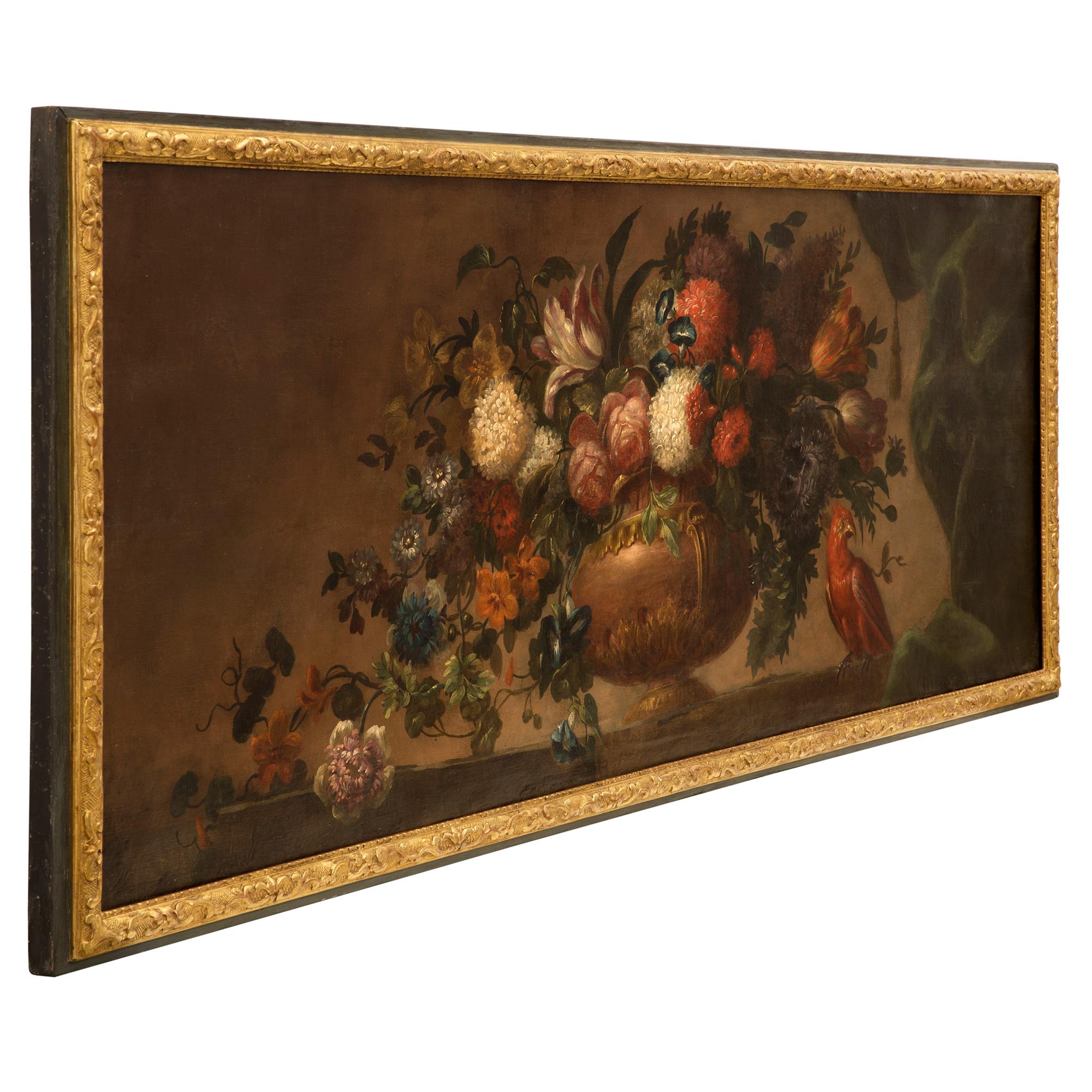 A beautiful French early 19th century Louis XVI st. oil on canvas painting. The still life painting is set within is original patinated green and giltwood frame and depicts an elegant large urn at the center with stunning and richly colored