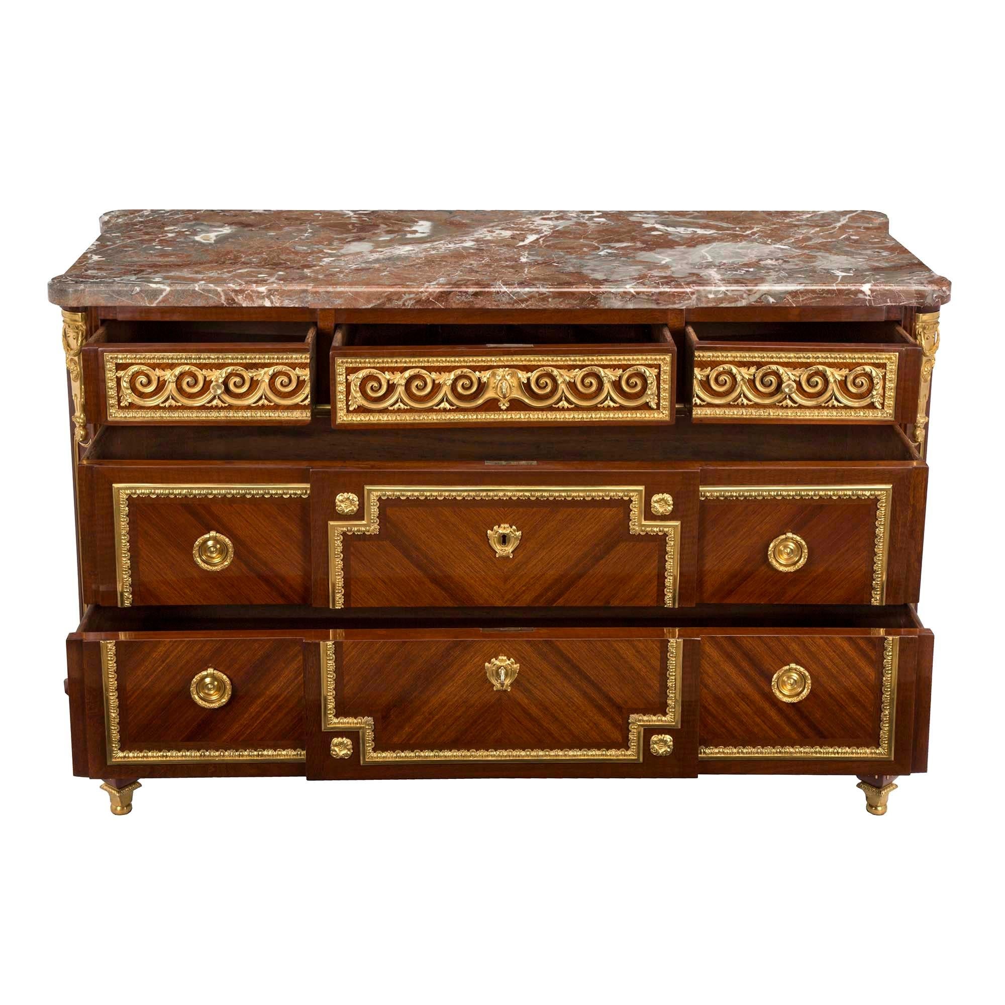 A magnificent and high quality French early 19th century Louis XVI st. tulipwood and ormolu five drawer chest. The chest is raised by unusual and most handsome square tapered feet with unique extremely decorative square and ball sabots below elegant