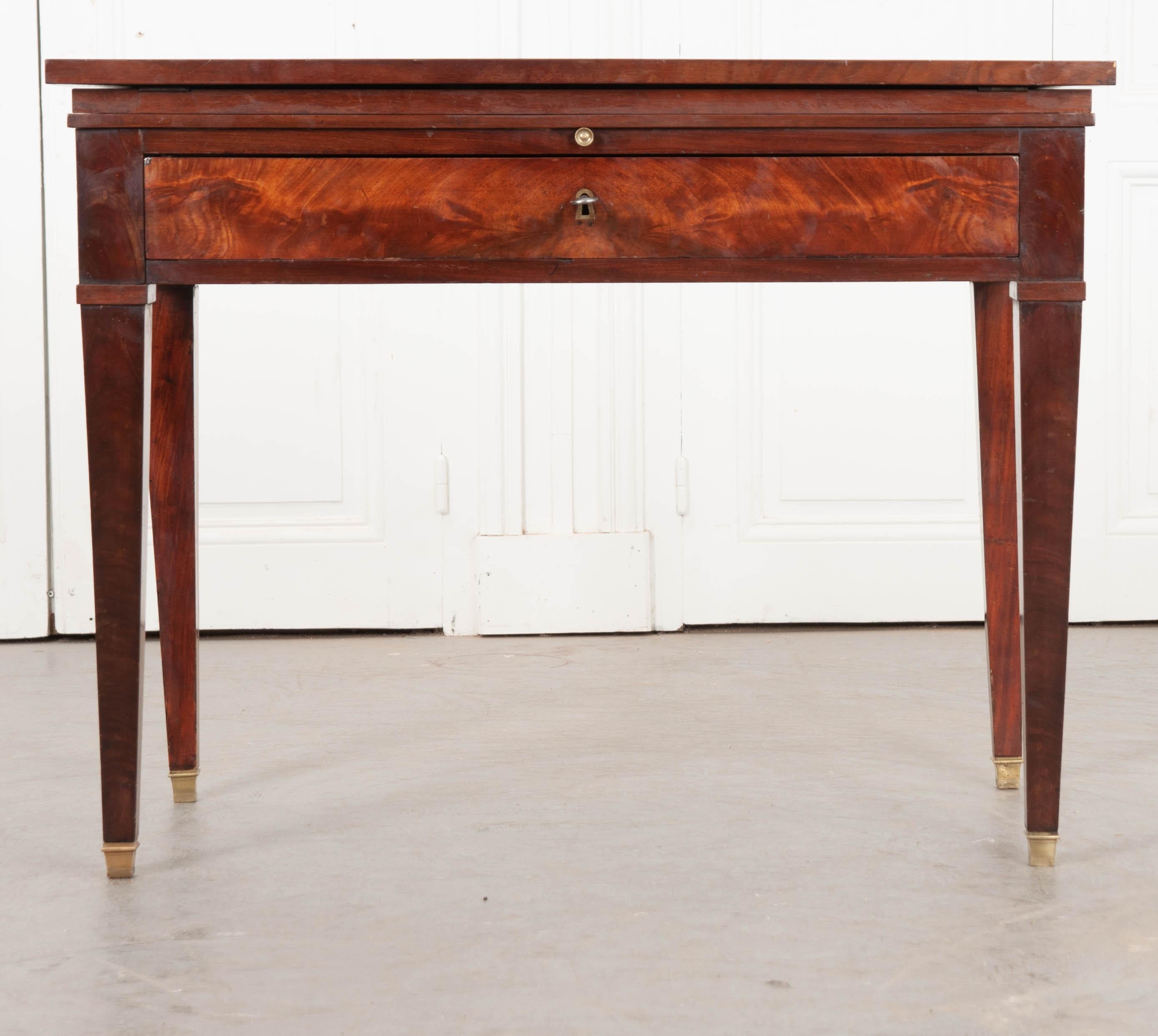 This specialized mahogany desk was made in France, circa 1810. Made in the Directoire style, this remarkable desk features a top that can be adjusted for sitting or standing. Used by architects and drafters, the desk’s tilted surface brings the back
