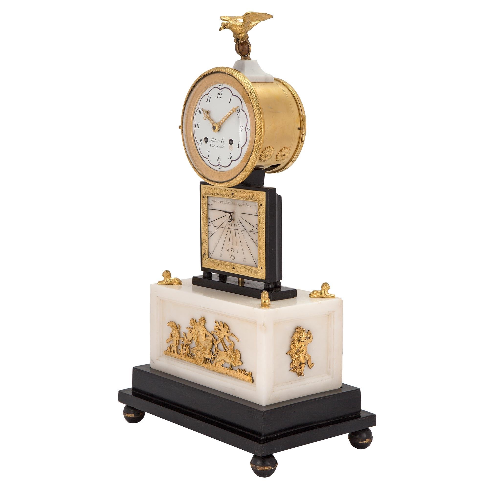 A very high quality and unique French early 19th century white Carrara marble and ormolu quarter strike clock with sundial, signed Robert et Courvoisier. The clock is raised on an ebonized fruitwood support with ball feet. The rectangular white