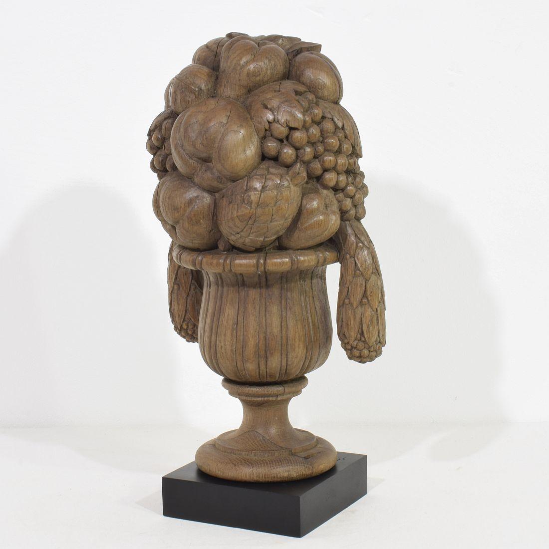 Wonderful early 19th century Neoclassical hand carved oak vase ornament in a good but weathered condition.
 France, circa 1800- 1850. 
Weathered
Measurements includes the wooden base.