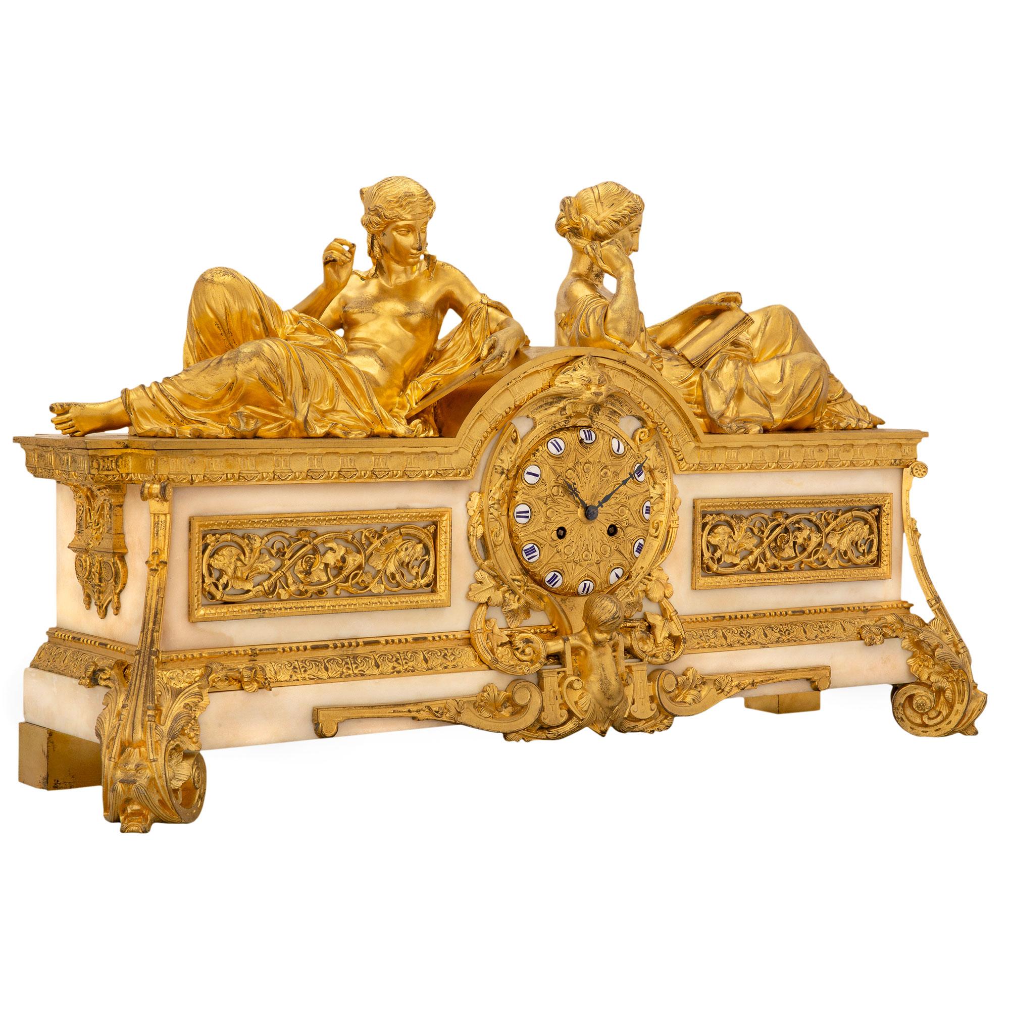 An impressive French early 19th century ormolu and white Carrara marble clock. The clock is raised by elegant scrolled foliate supports with dolphin heads. The rectangular white Carrara marble base is decorated with a striking array of richly chased