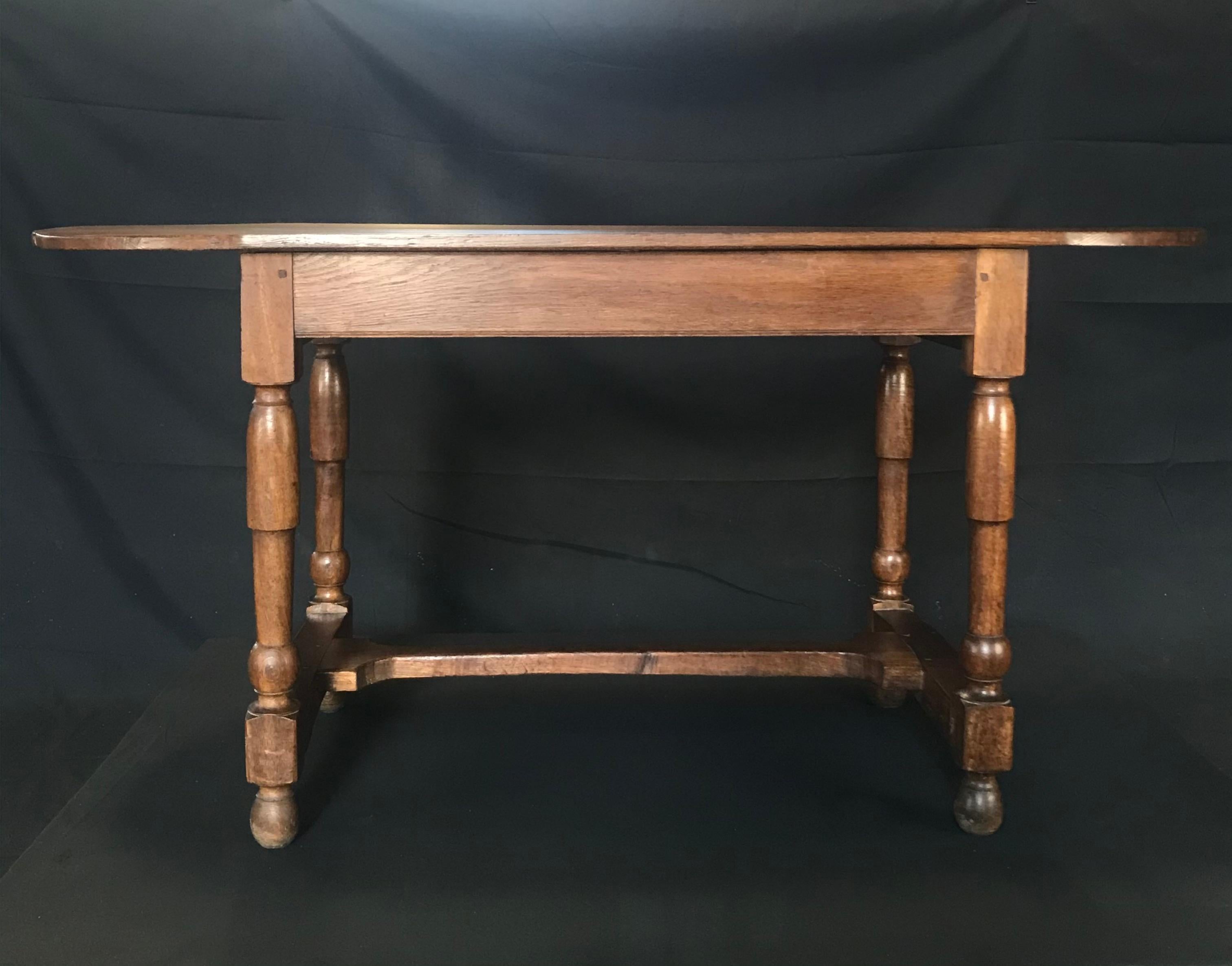 Wonderful size in this French early 19th century provincial farmhouse style walnut oval table that could serve many uses: intimate dining table, desk, or floating side table or center console table. Legs are beautifully turned, with lovely dovetail