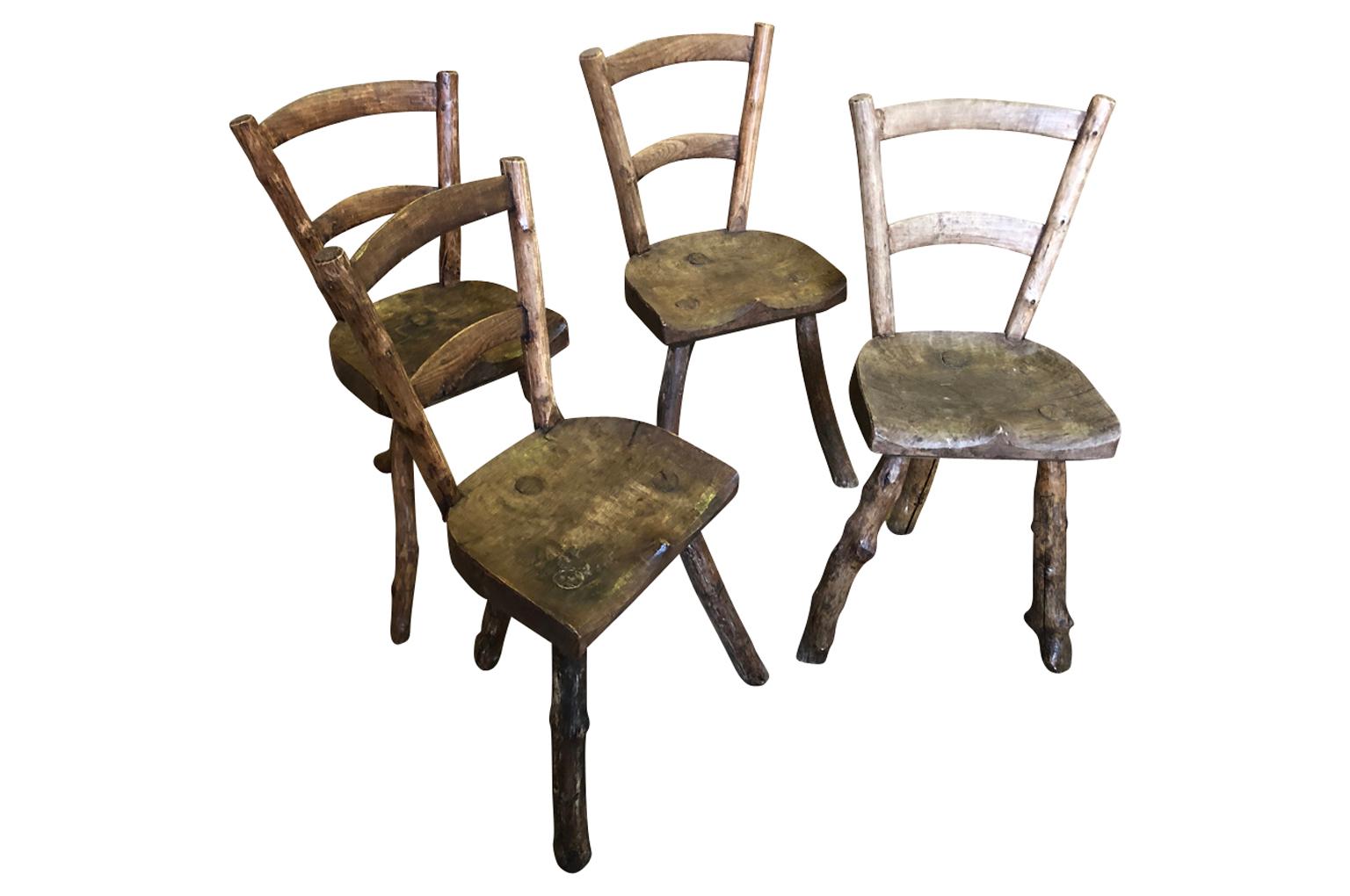 A very charming early 19th century set of 4 primitive chairs from the Provence region of France in naturally washed apple and chestnut wood. Delightful accent pieces.
