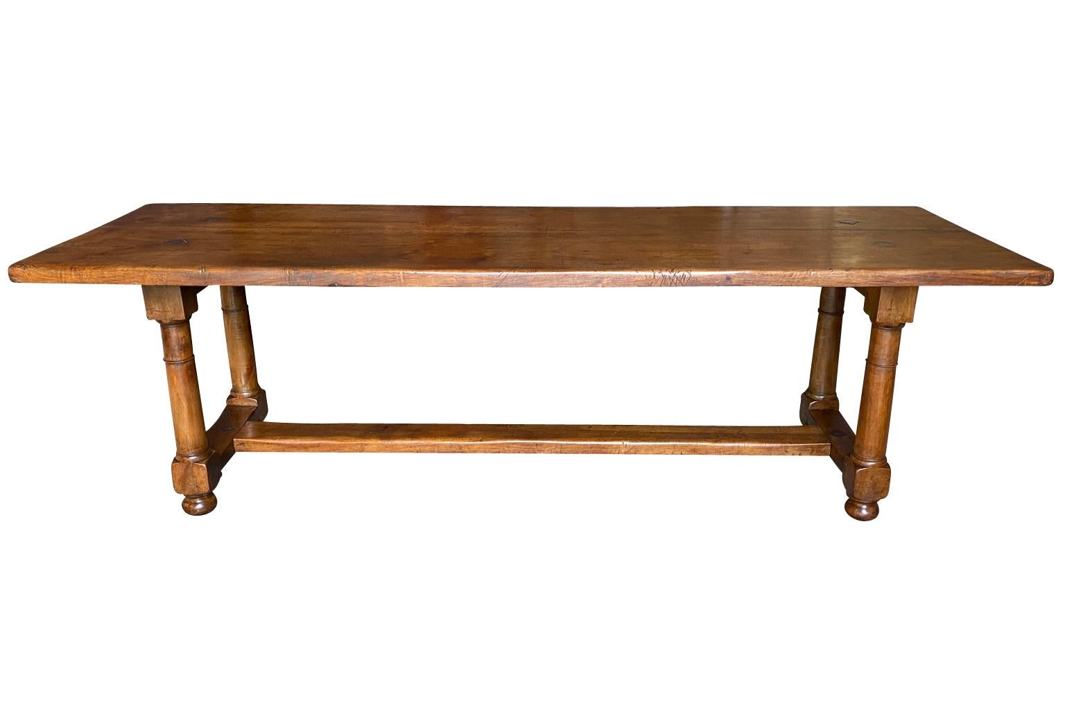 A very lovely early 19th century Trestle Table - Farm Table from the Provence region of France.  Soundly constructed from stunning walnut with a thick top plank, column legs resting on bun feet.  Beautiful patina.