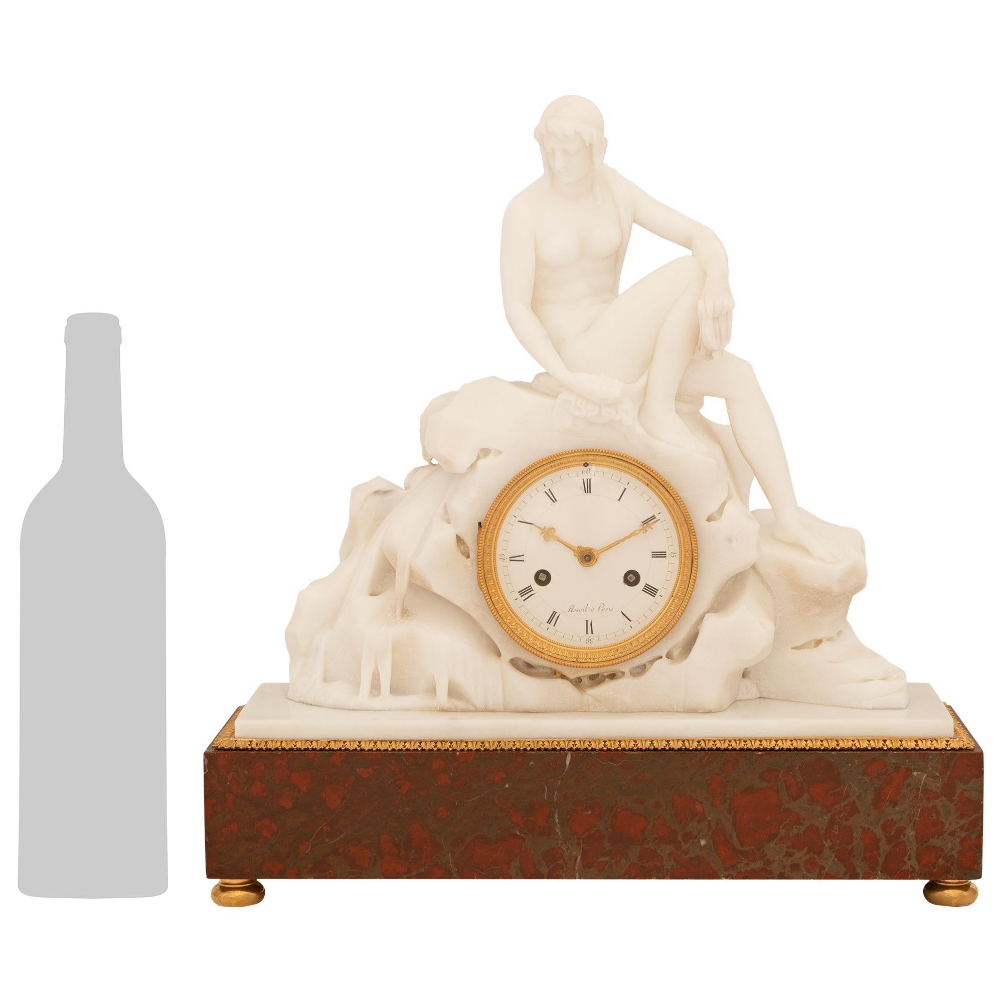 A beautiful and most attractive French early 19th century Neo-Classical st. white Carrara, Rouge Griotte marble and Ormolu clock, attributed to Étienne Maurice Falconet. This wonderful mantel clock is raised on a rectangular Rouge Griotte marble