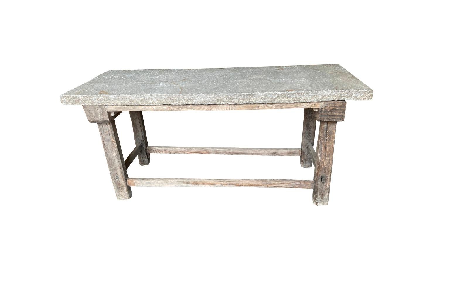 A terrific early 19th century primitive work table - console from the Ardeche region of France. Wonderfully constructed from a naturally washed pine and an impressive thick stone top. Perfect as a kitchen island, a potting table or console.