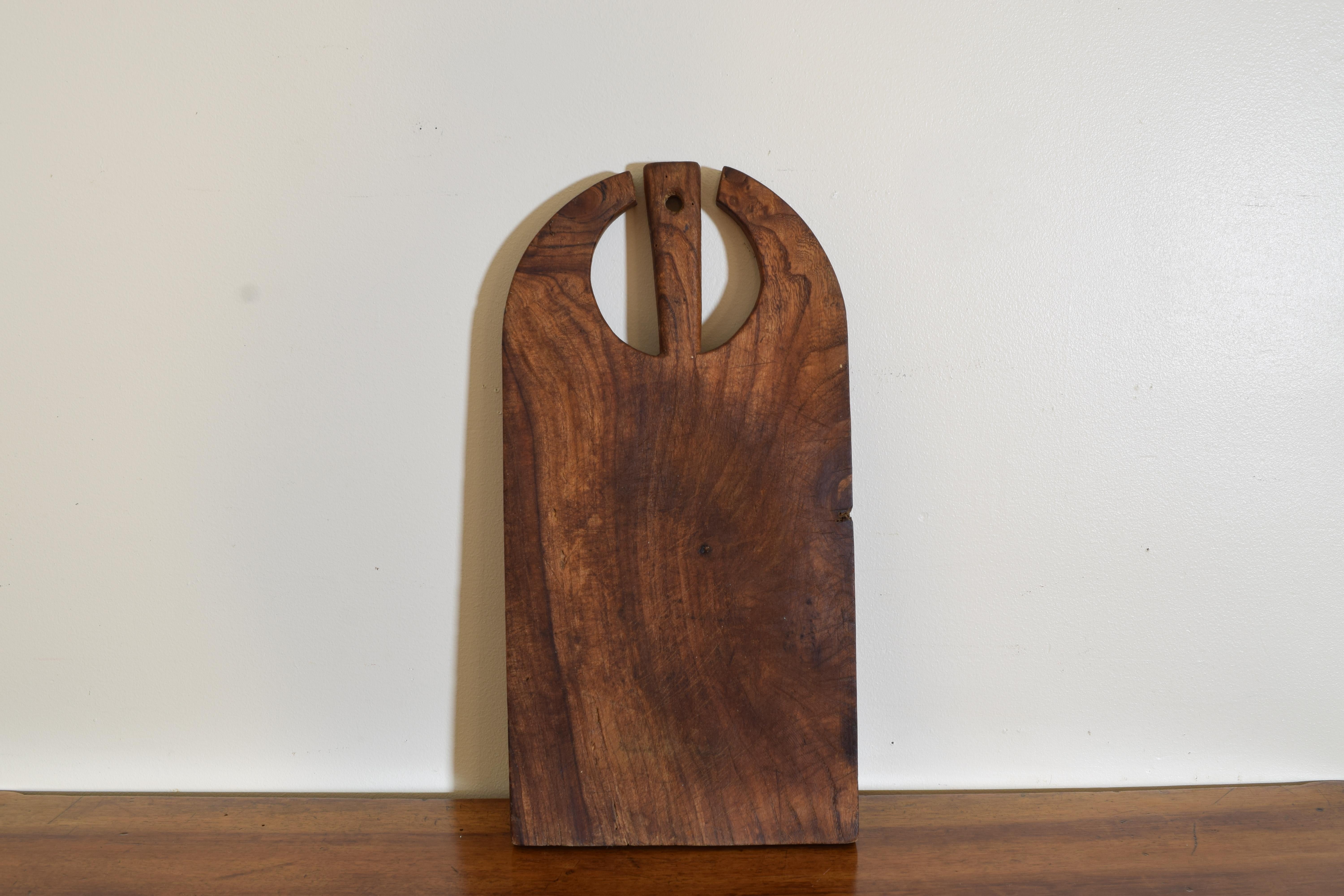 An unusually shaped cutting board with handle