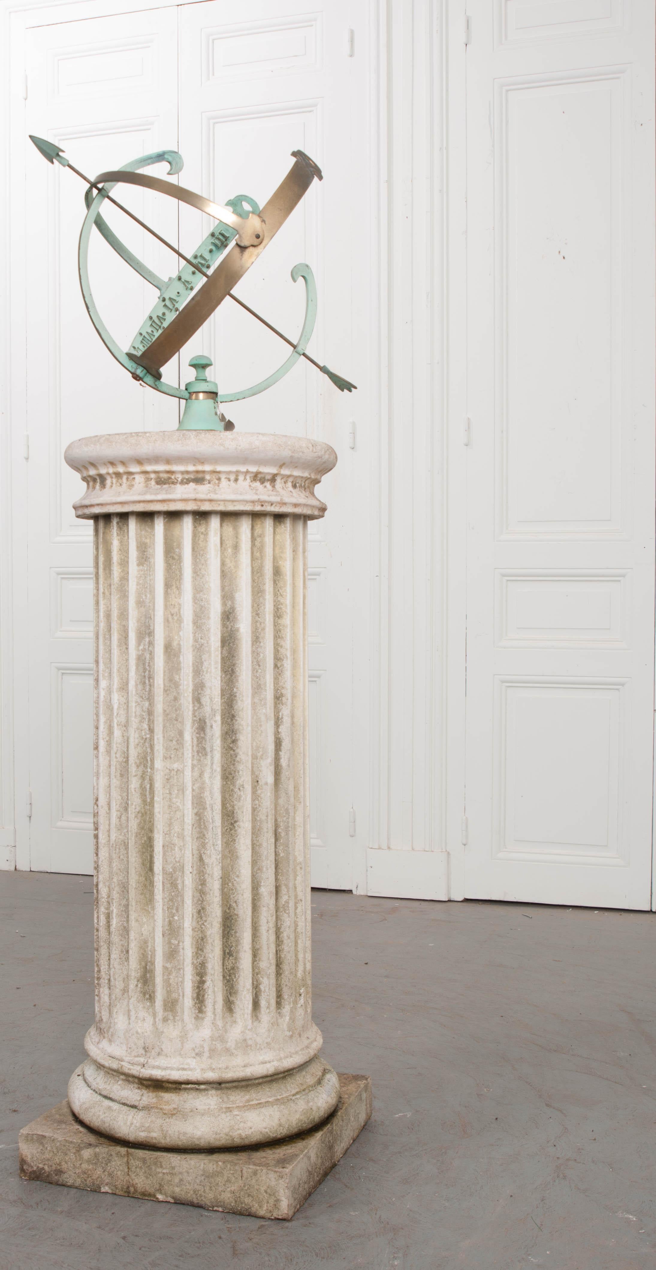 A marvelous 20th century French copper and brass armillary, resting atop a column-form pedestal. The fluted pedestal has a 16? diameter and made of reconstituted stone that has acquired excellent patina from years of outdoor exposure. It supports