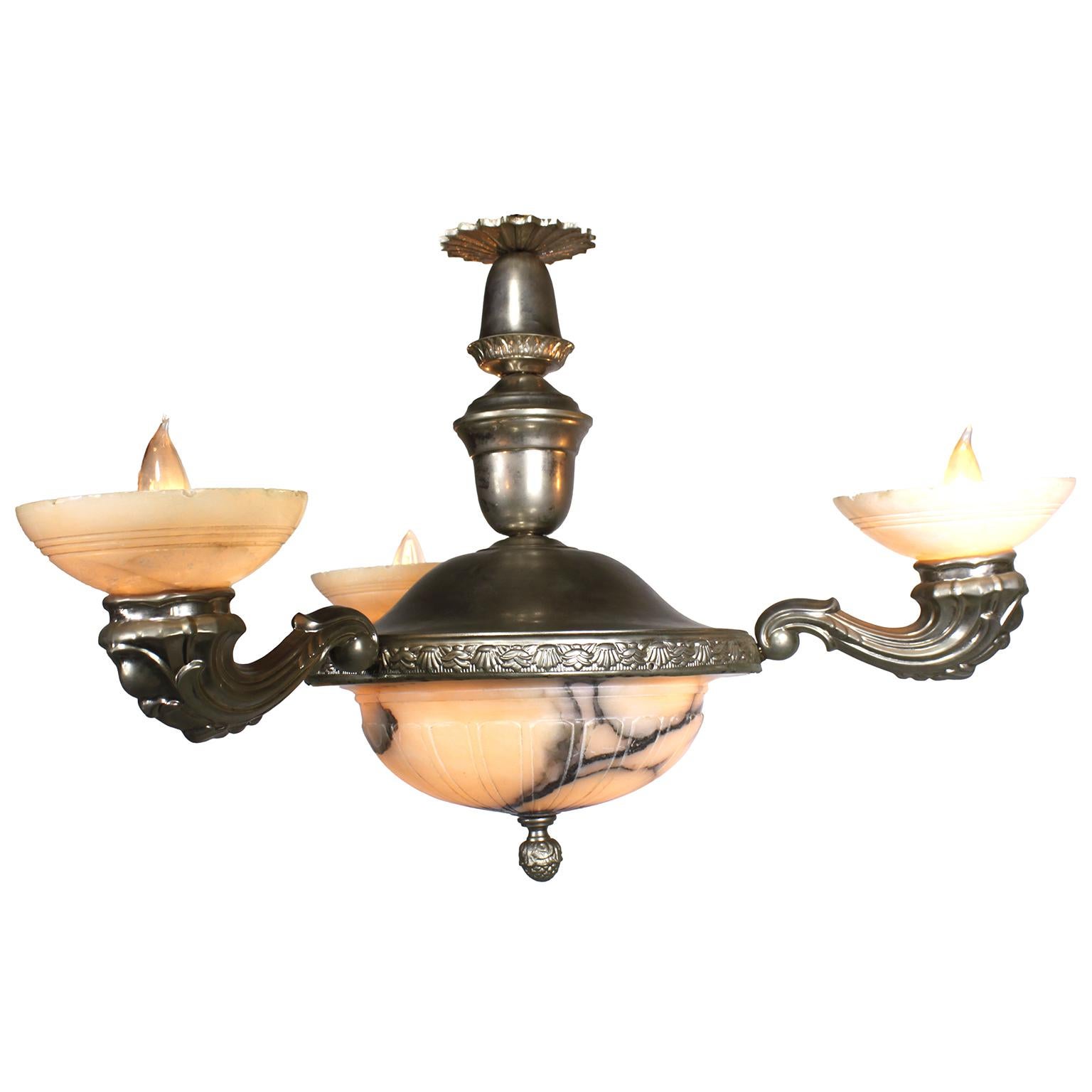A French Early 20th Century Art Deco Silvered Metal and Carved Veined Alabaster Three-Light Chandelier. The circular silvered frame suspended by a center stem with a sunburst canopy, with three scrolled cornucopia shaped arm-lights, all fitted with