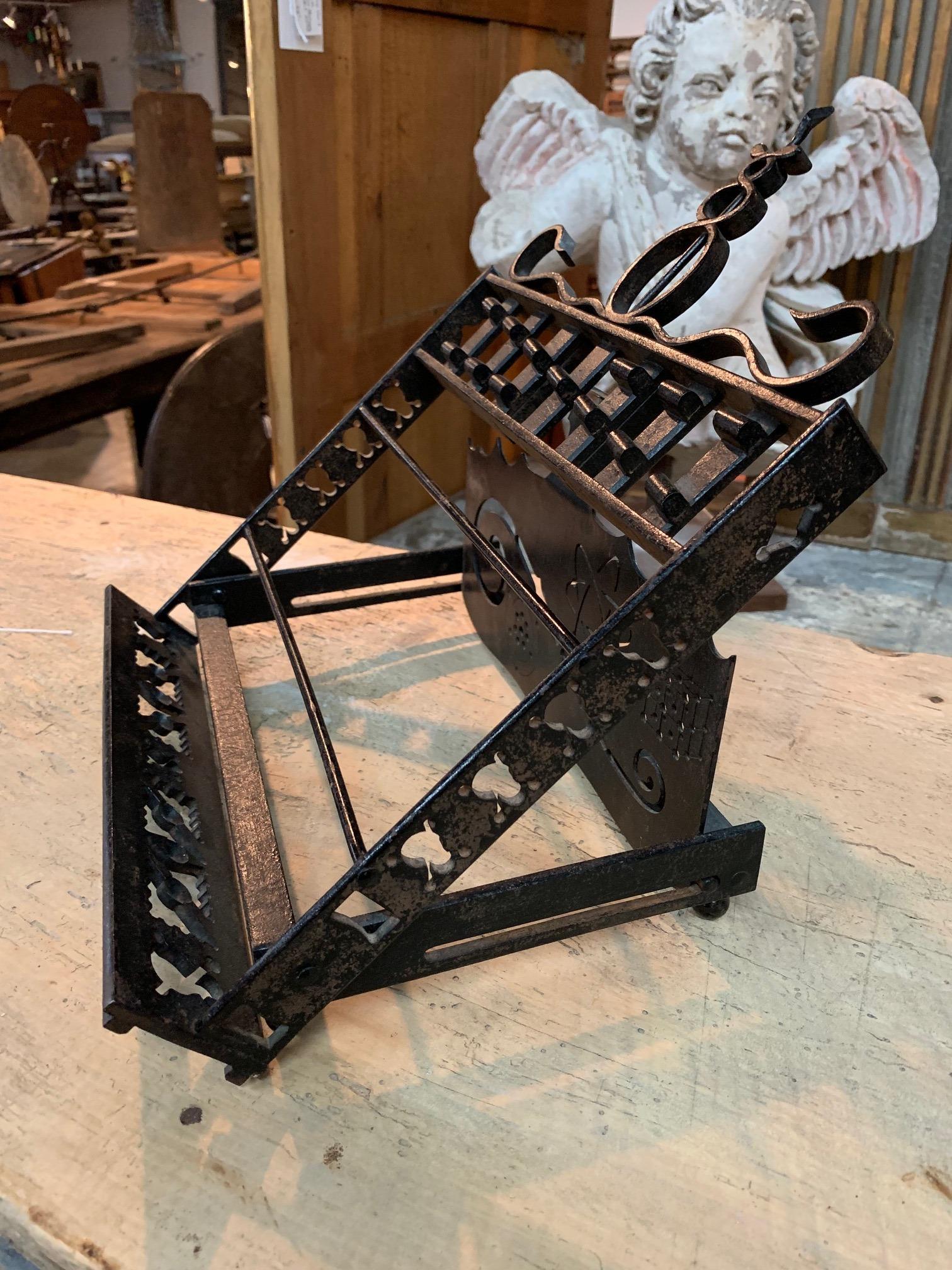 A very handsome French early 20th century Arte Populaire book rest or bible stand. Beautifully crafted from painted iron with medical, cosmos and skull and cross bone motifs. Also wonderful to display a painting from.