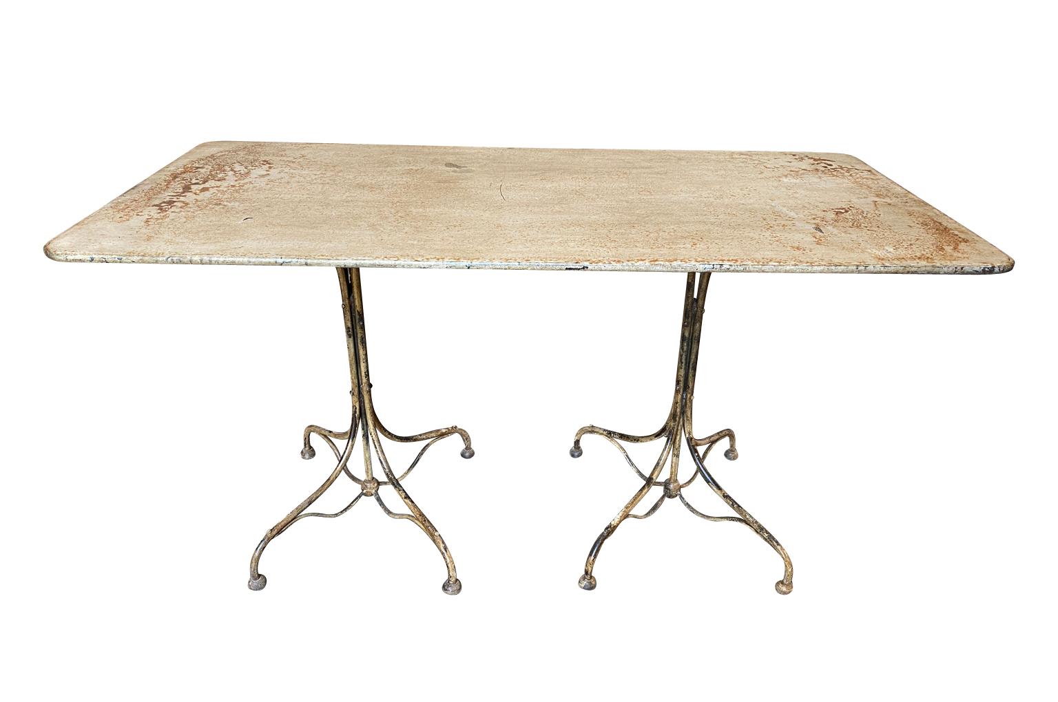A very charming early 20th century Bistro table - Garden table from the Provence region of France. Soundly constructed from painted iron with a unique double form. Perfect for any solarium or garden.