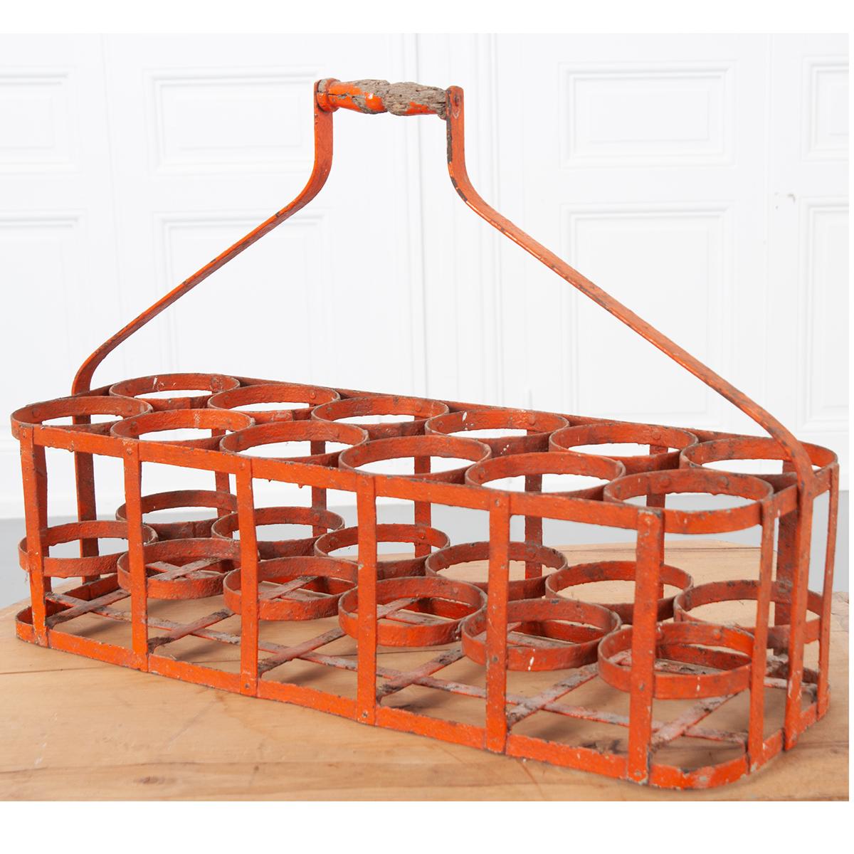 Early 20th century, circa 1900, 12 bottle carrier basket from France. Handmade bottle rack, made of metal with a wooden handle. Wonderful, aged patina gives this basket layers of character.