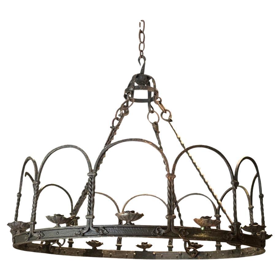 A very handsome early 20th century Chandelier from a grand salon in Fontainebleau. Beautifully crafted from riveted hand forged iron. 