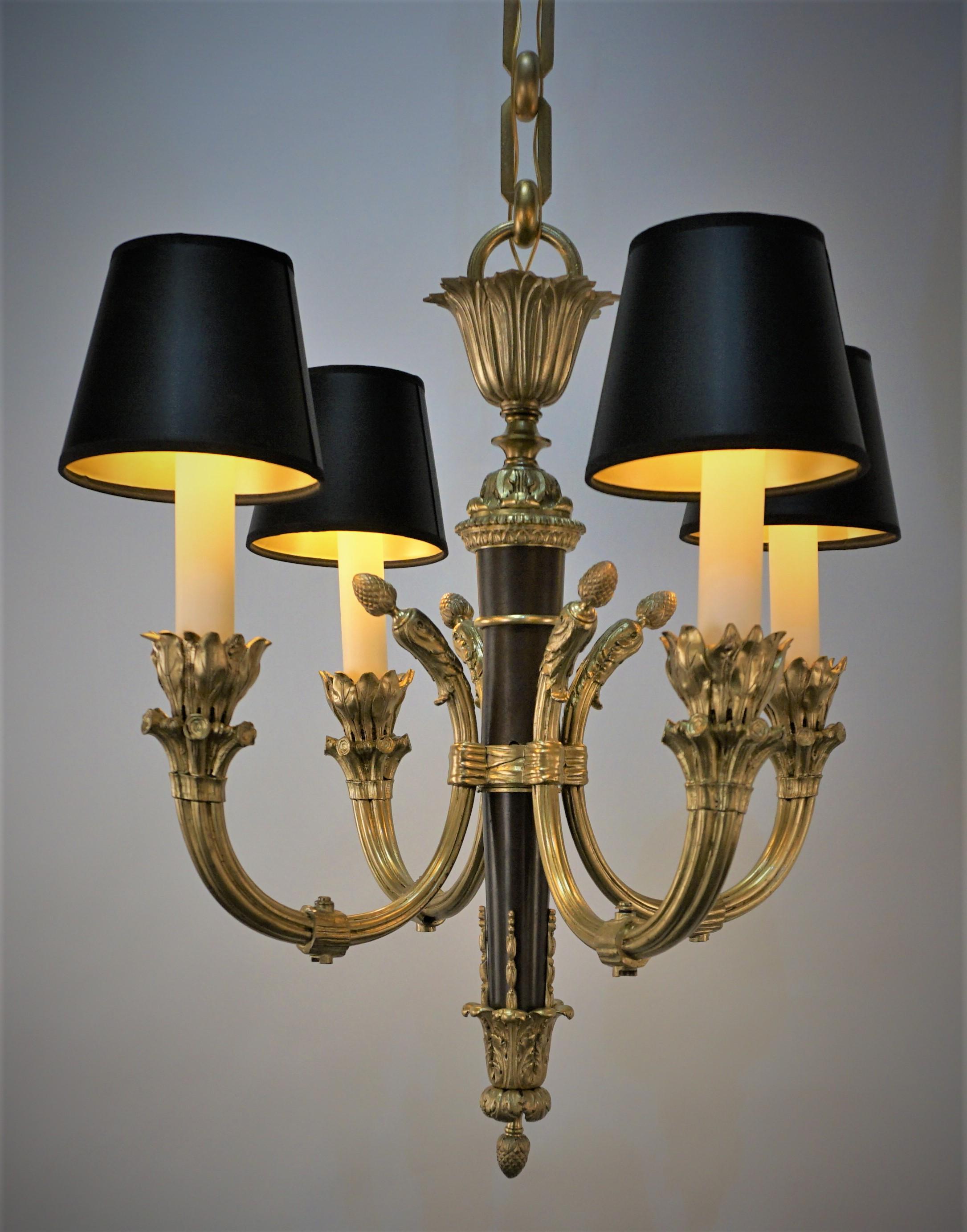Elegant French bronze empire gold and brown finish four arm chandelier. 
 Measurement: width 24