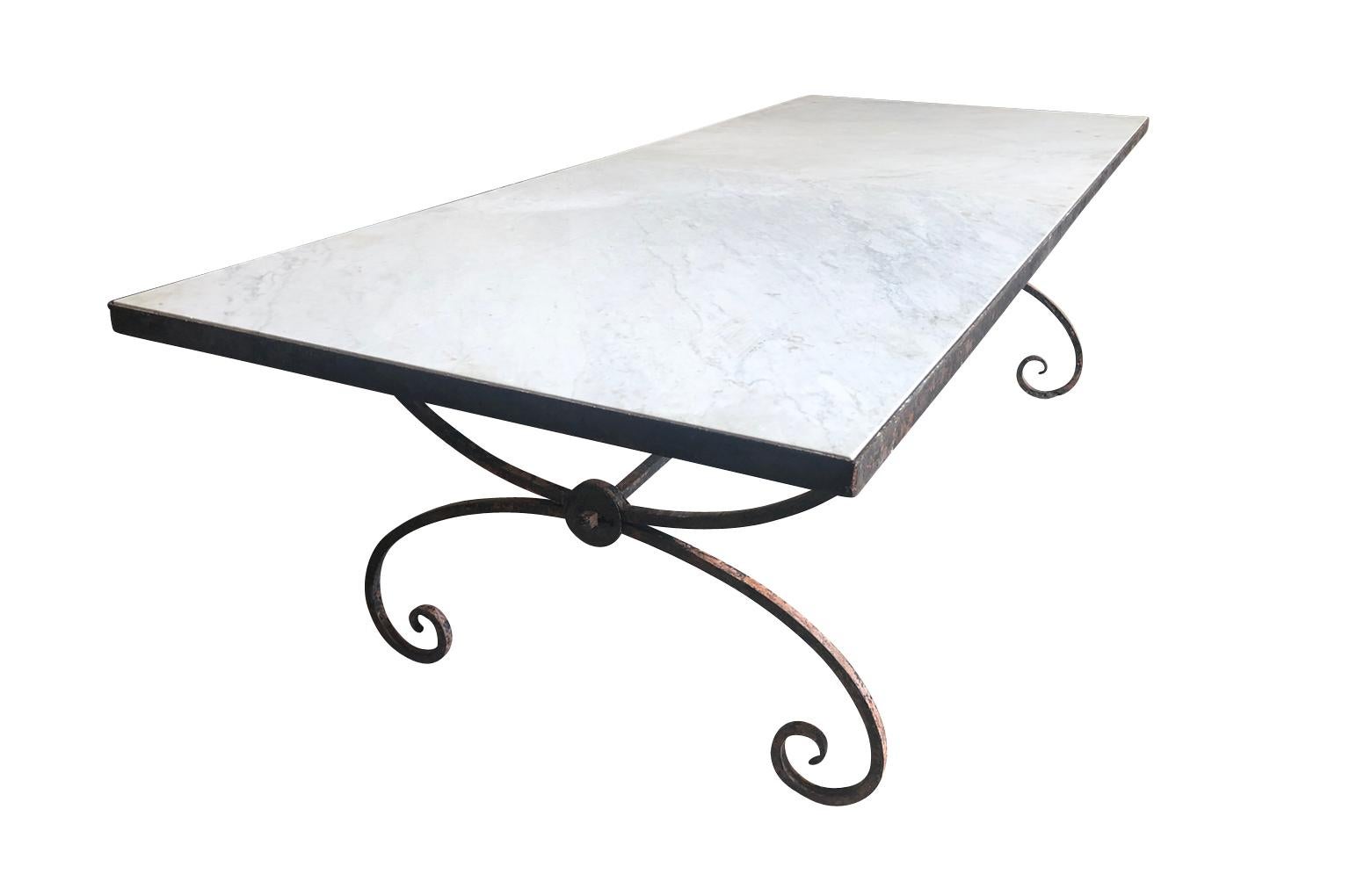 A sensational early 20th century garden dining table from the South of France. Very soundly constructed from beautifully patina'd painted iron with a marble top. The marble is in 2 pieces. Perfect for large family gatherings indoors or out.