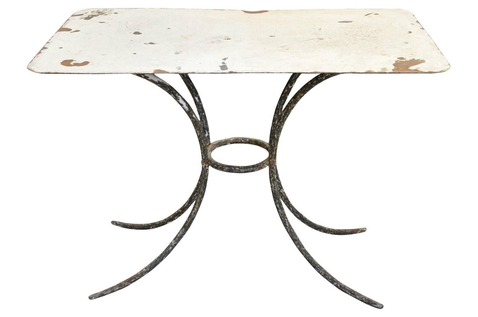 An early 20th century garden table - bistro table from the South of France in painted iron.