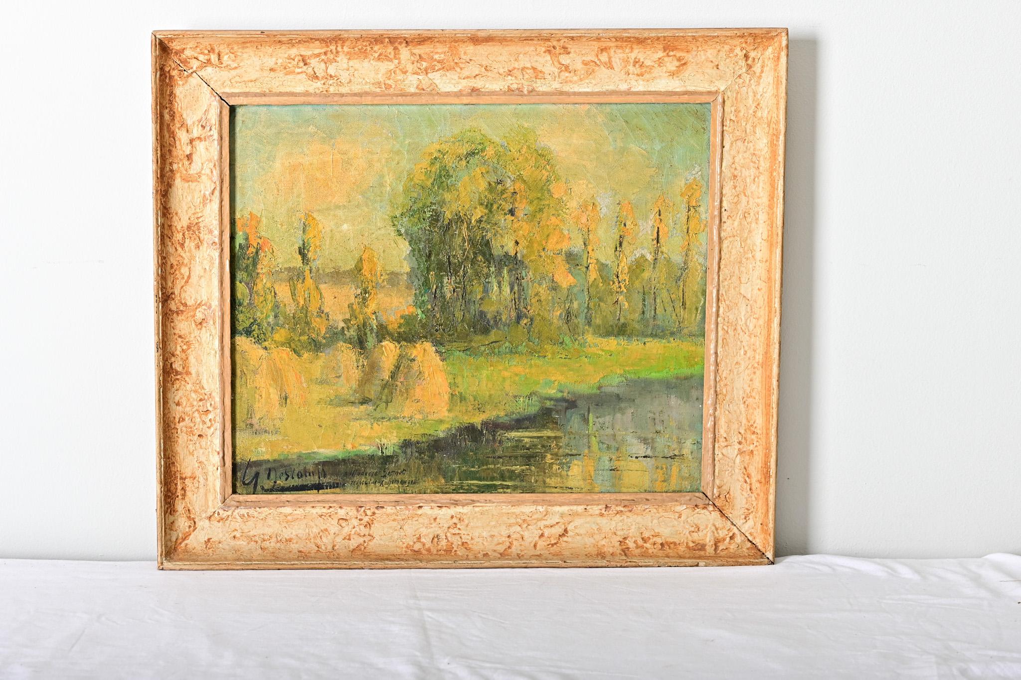 French, early-to-mid 20th century abstracted oil on canvas landscape by Henri Descamps (1898-1990). The hazy technique emphasizes the bright color palette and impasto texture of the trees along a riverbank, mounds of hay on the embankment to the