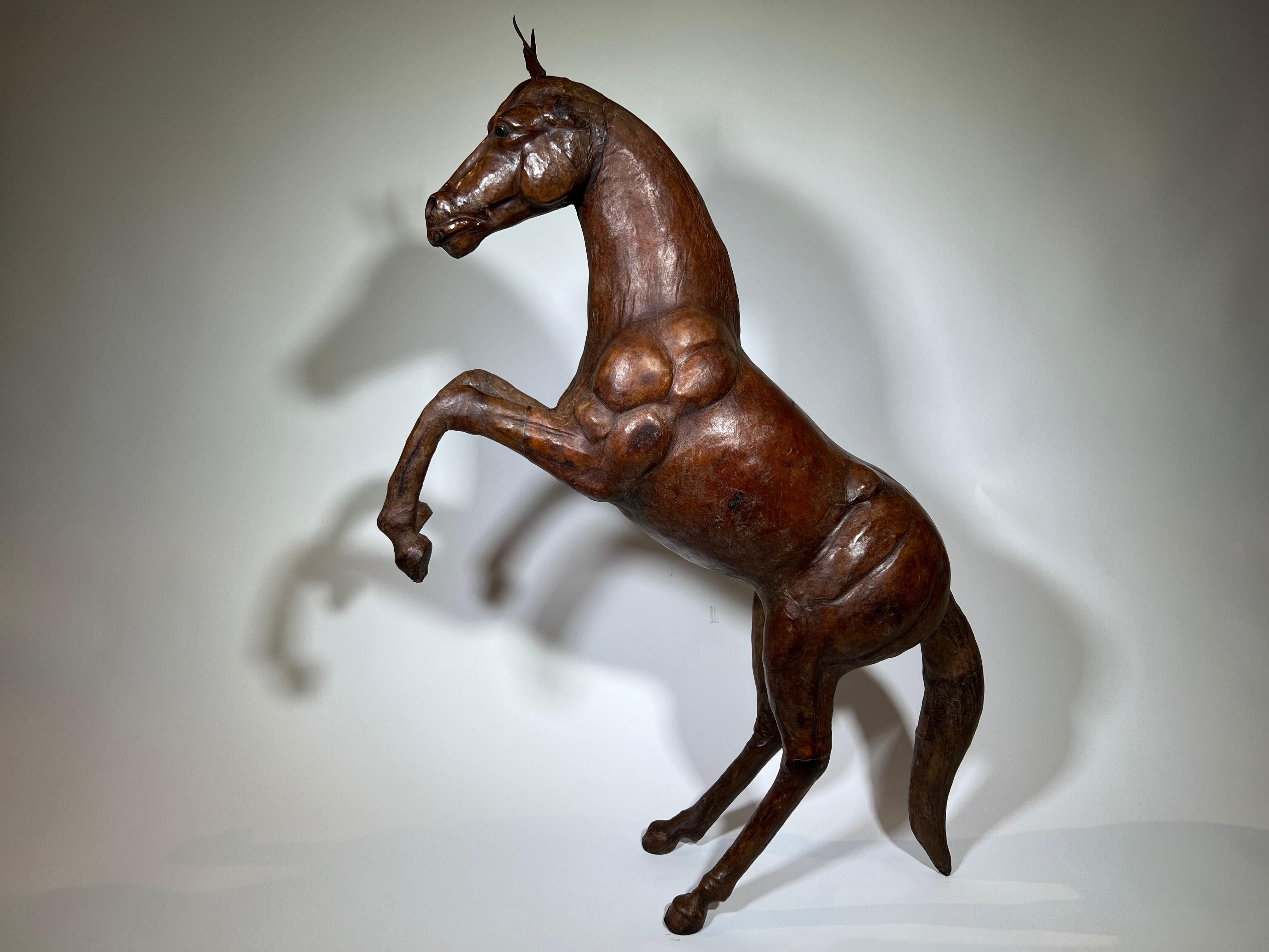 A very handsome early 20th century French Leather Horse Sculpture. Beautifully poised in a rearing position. Wonderful patina. A terrific accent piece for any living area.