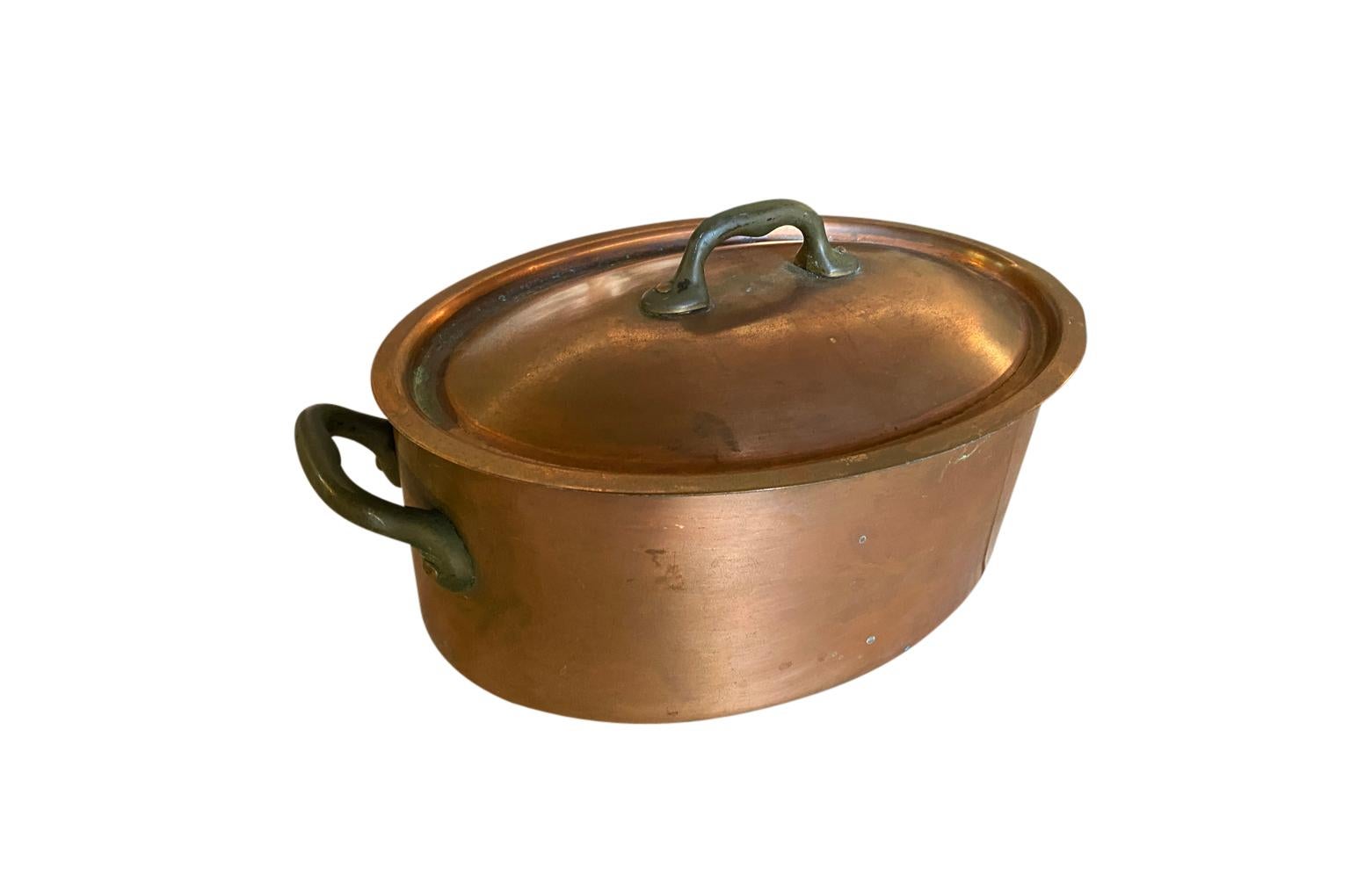A very charming early 20th century lidded copper pot in an oval shape.  A wonderful addition to any copper collection.
