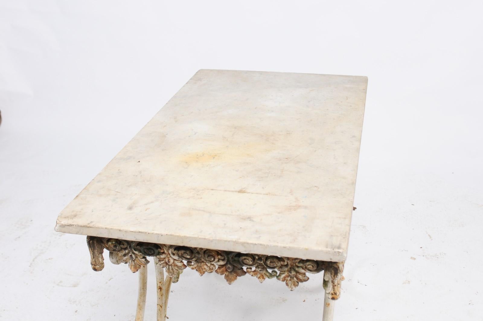 French baker's table from the early 20th century, with rectangular marble top, scrolled apron and base. We had seen this unforgettable pastry table a few months prior and had fallen in love with it. When we found it again at a fair in France, we