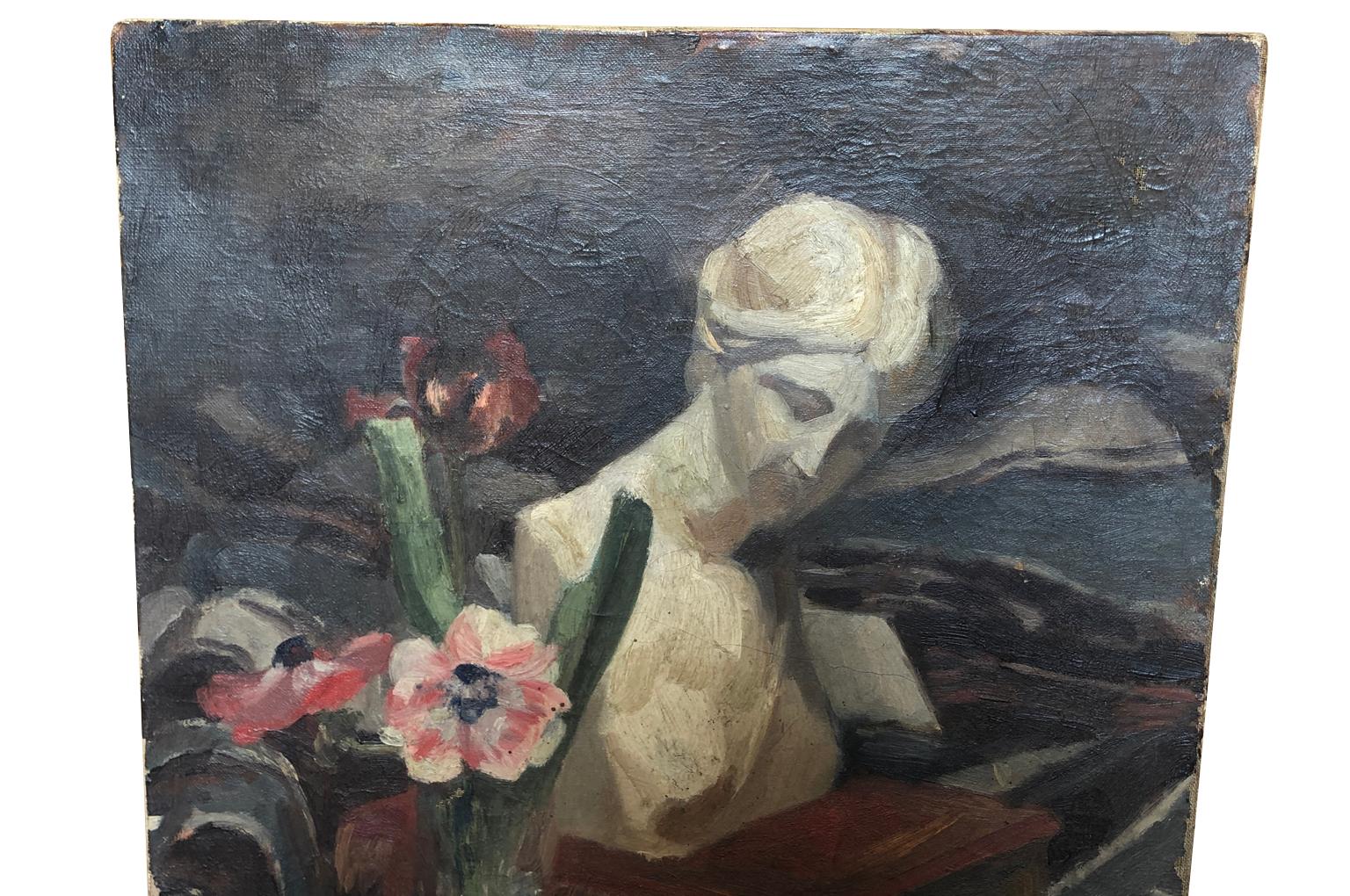 A very charming French early 20th century Nature Morte - Still Life. Oil on canvas, a wonderful grouping of a bust, flowers and books. Wonderful craquelure and brush work.