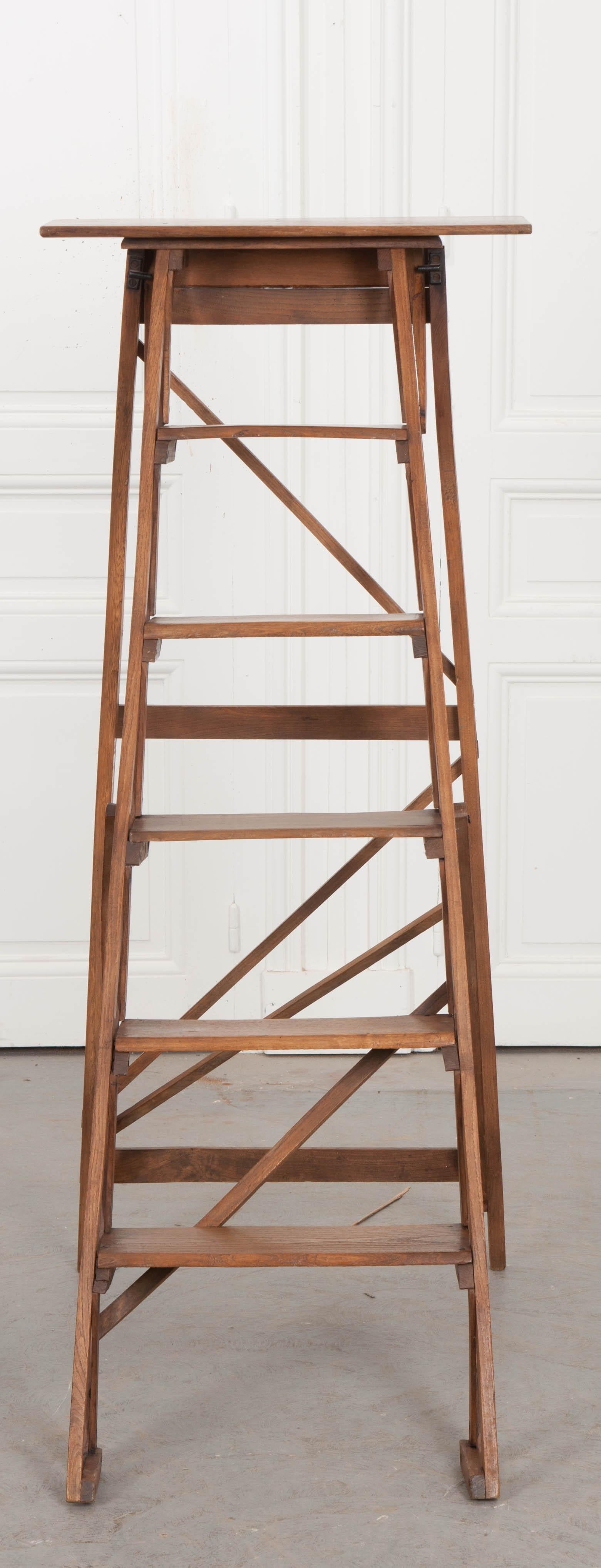 An exceptional antique folding ladder from 1900s France. The oak ladder has five steps that are graduated in size. When opened, the ladder measures 53 1/4? H. The lightly-toned oak used to construct the antique has taken a lovely patina over the