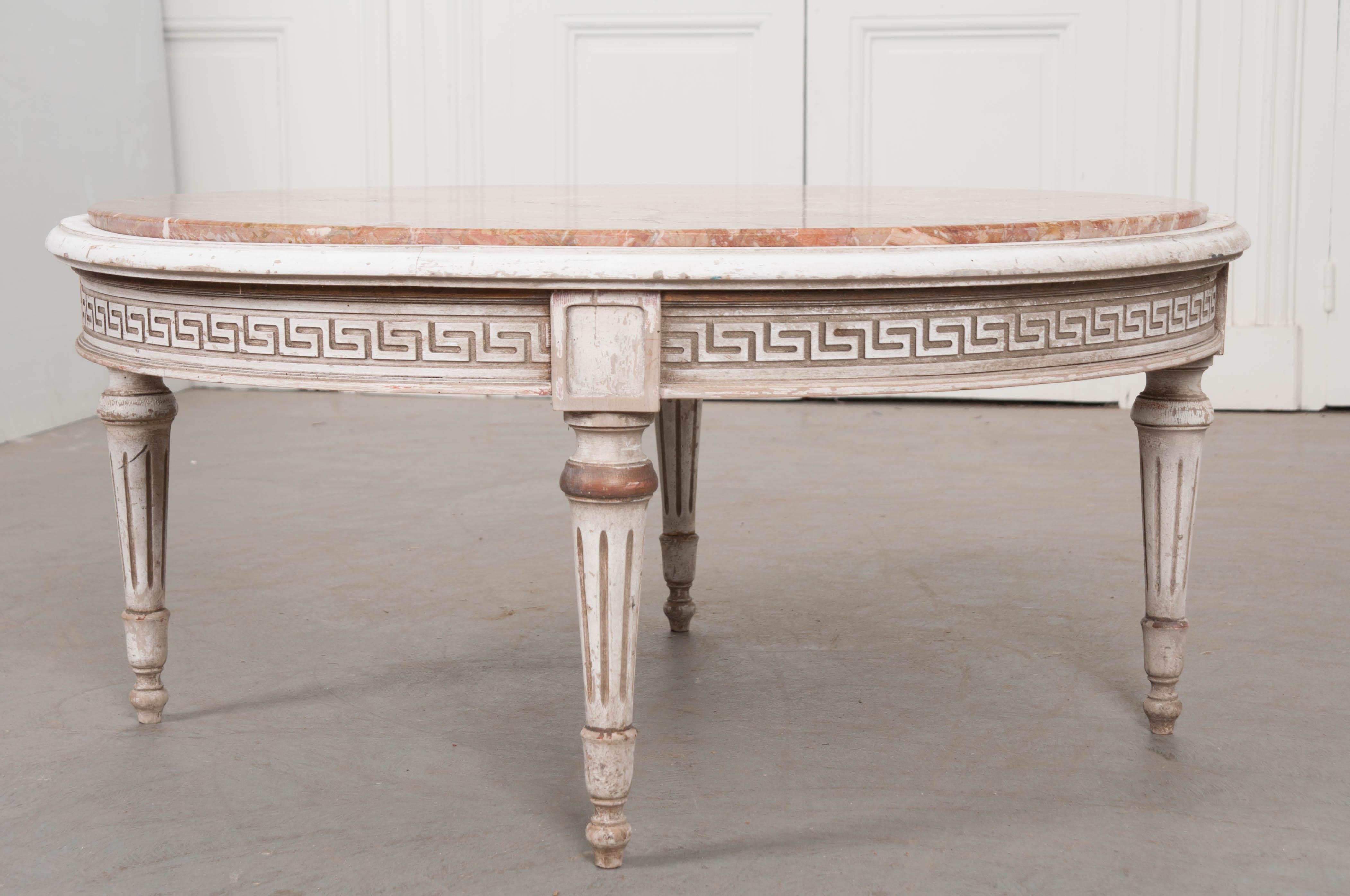 A gorgeous round coffee table, made in France, circa 1900, with exceptional red marble top. The table has four turned and tapered legs with fluted details that lift the table and meet the top at the table’s apron. The circular apron has been styled