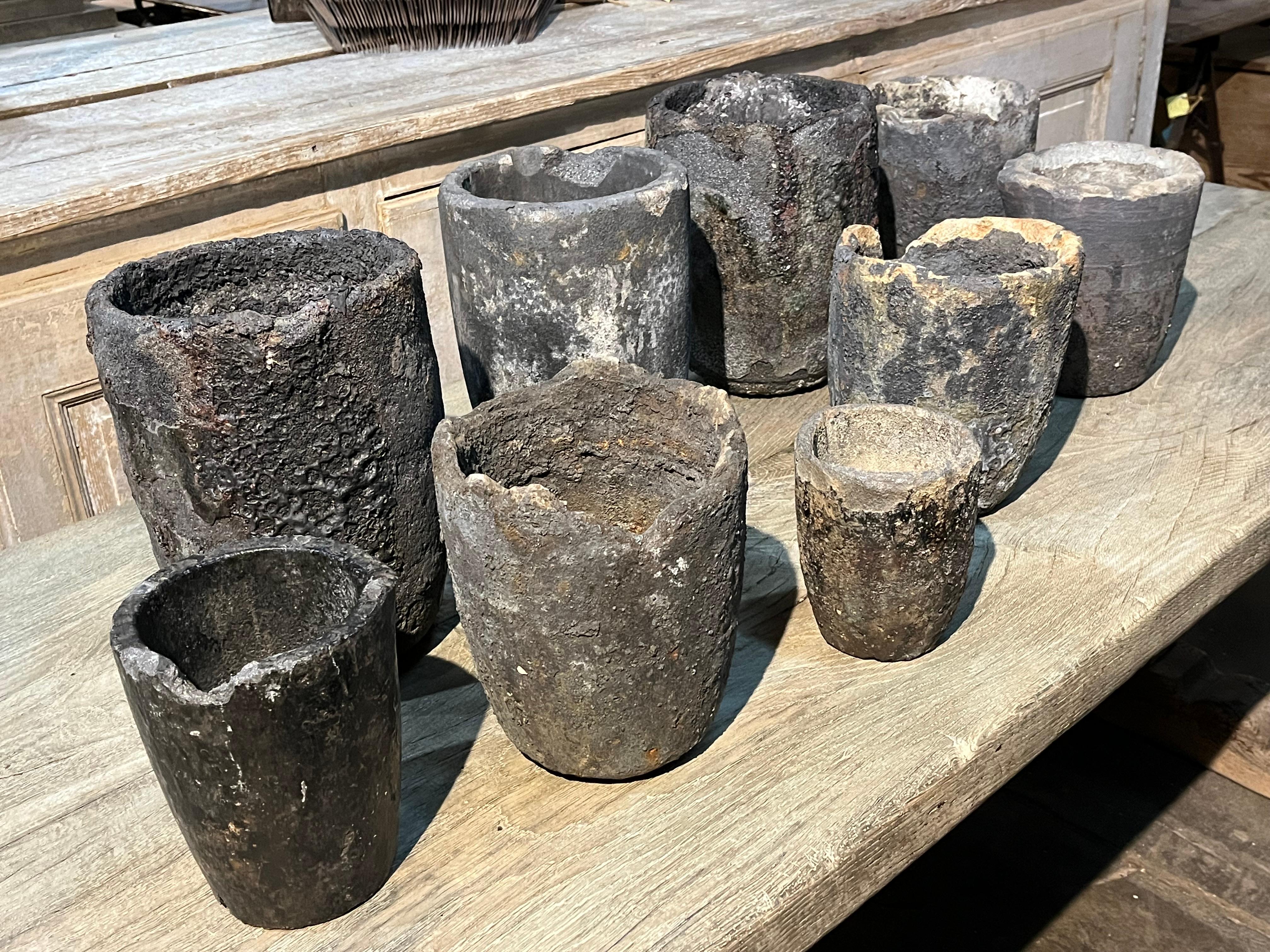 A terrific set of 9 early 20th century Creuzet - foundry Pots from France of unusually small scale. Fabulous patina. Fabulous as jardinieres or planters. Perfect for any interior of garden. A Crucible was made from a lava-like Material with a much