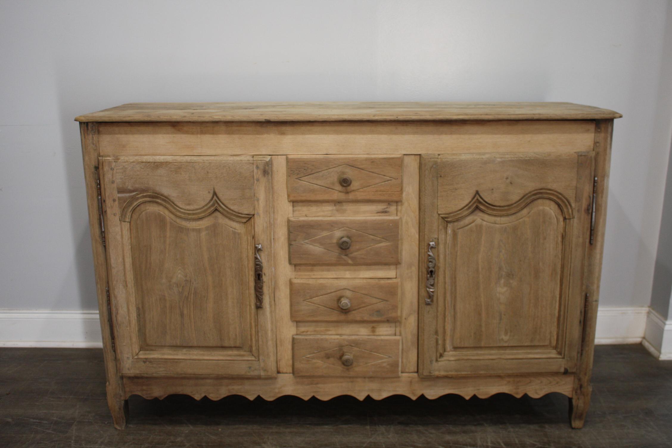 This sideboard is made of oak and has been refinished. It is narrow and can be placed anywhere in a home.
