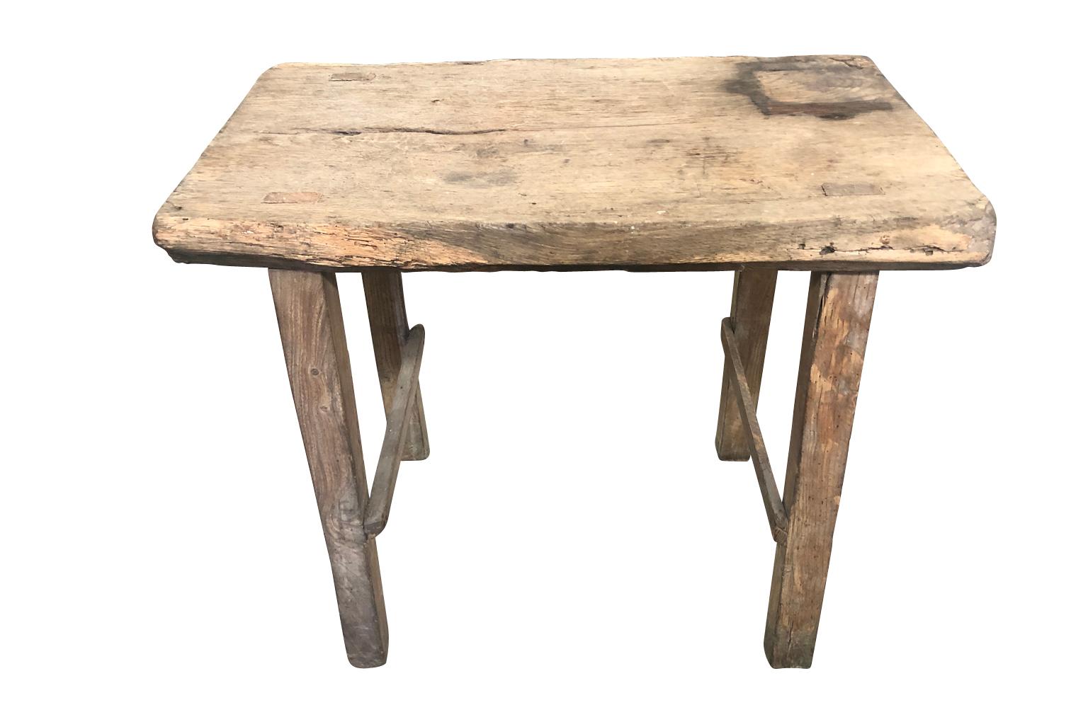 A charming and rustic early 20th century work table, side table from the Provence region of France. Soundly constructed from naturally washed oak. A wonderful piece for any rustic interior or covered porch.