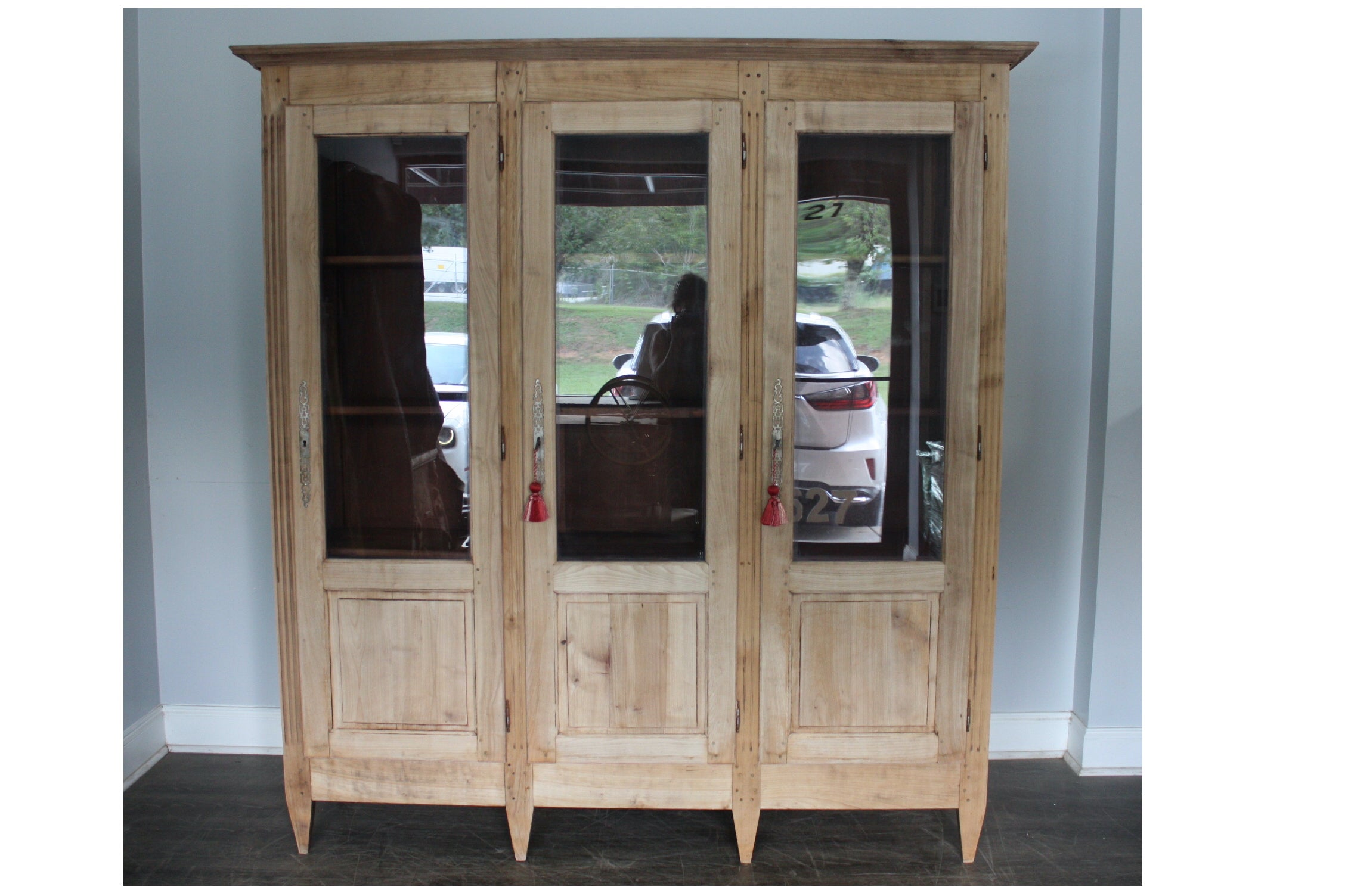 This Vitrine 3 doors has been refinished and has a thin Burgundy paint color inside. The left and right inside dimensions of the doors is 22.5''W x 13''D
The center door is 21.25''W.
