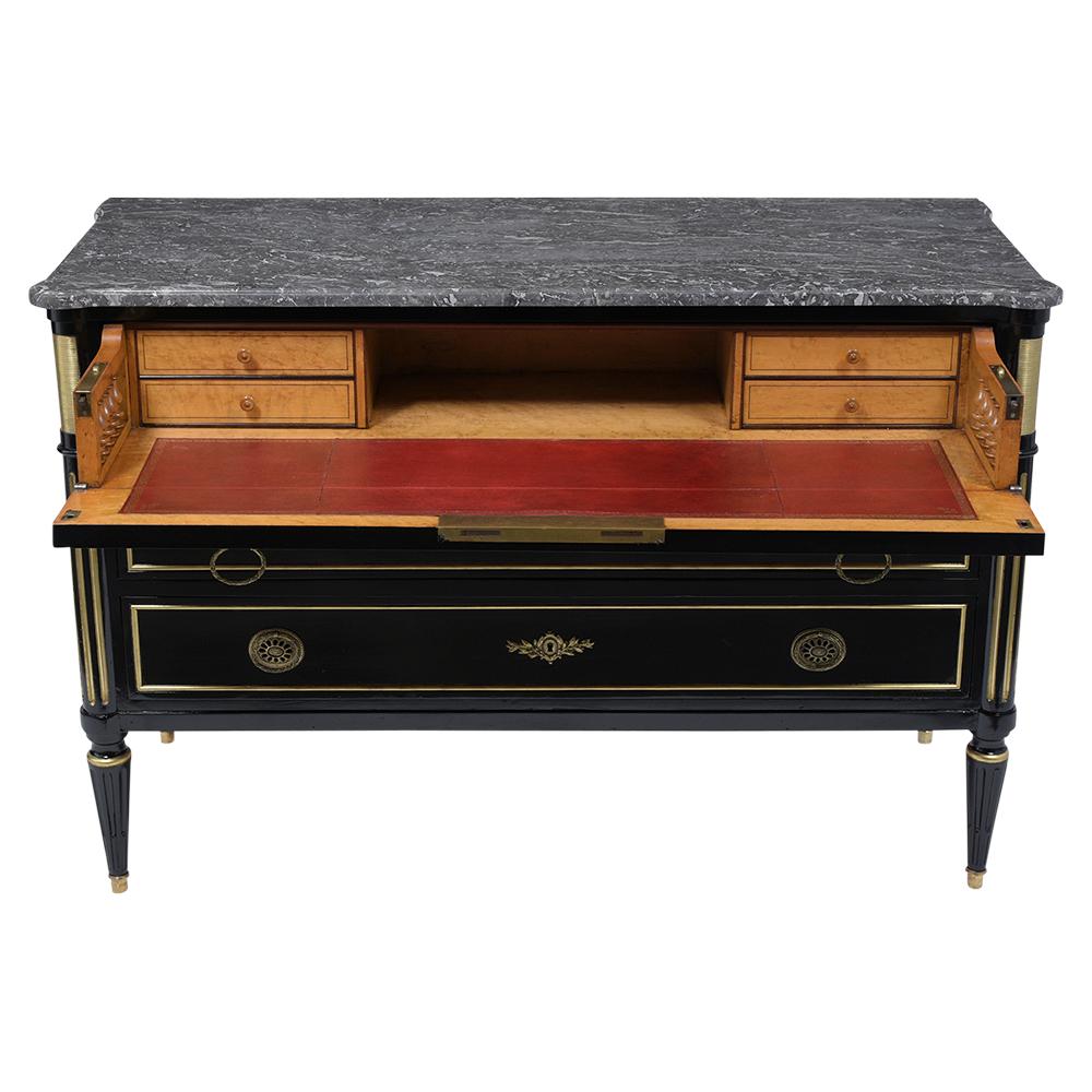 This Late 19th century Louis XVI Secretaire has been completed restored is made out of mahogany wood with a remarkable new ebonized finish and comes with its original dark grey beveled marble top. The Commode features three pullout drawers with flat